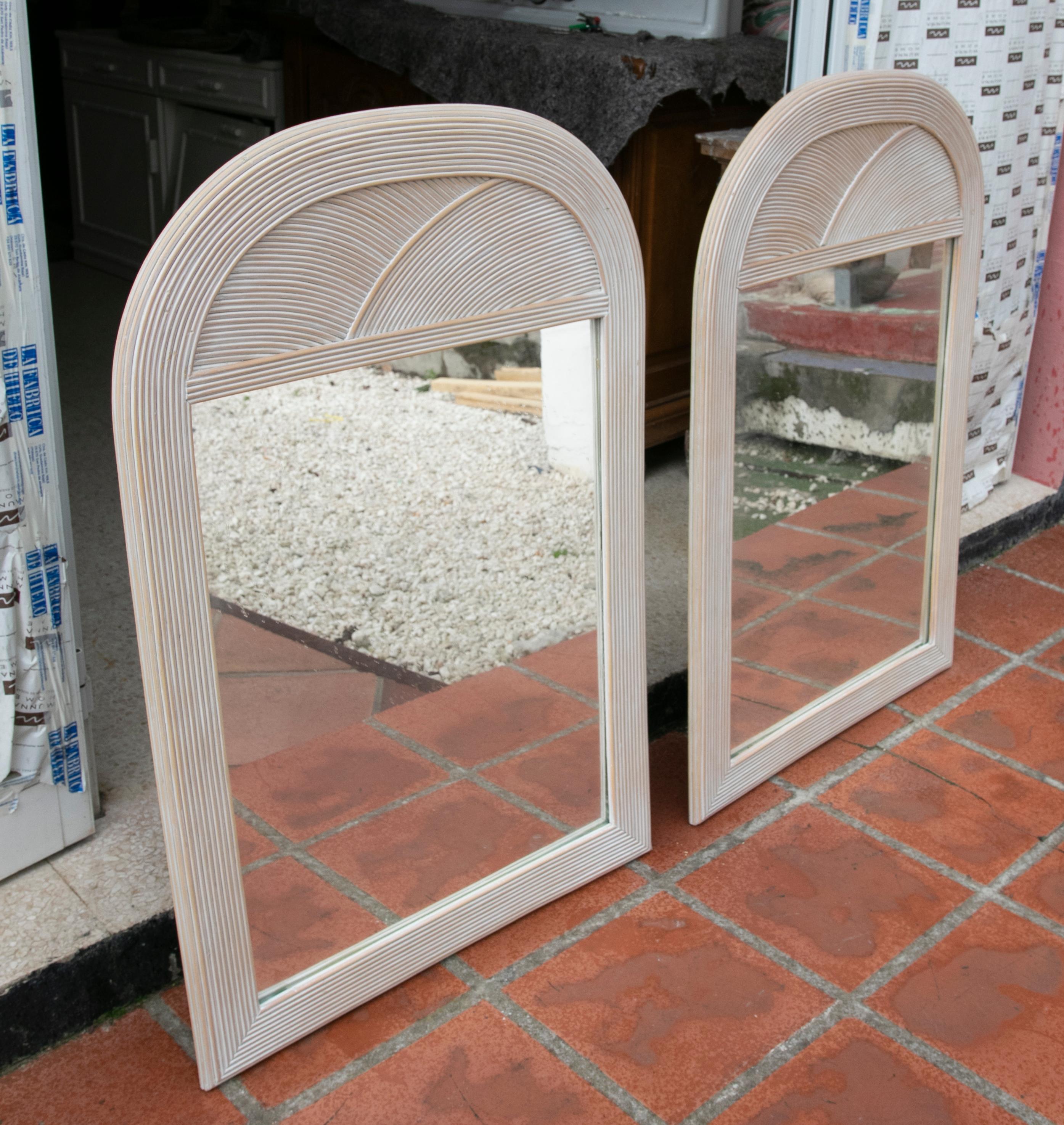 1980s pair of wicker wall mirrors.