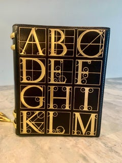 Bolso libro Paloma Picasso negro y dorado de los años 80 Embrague