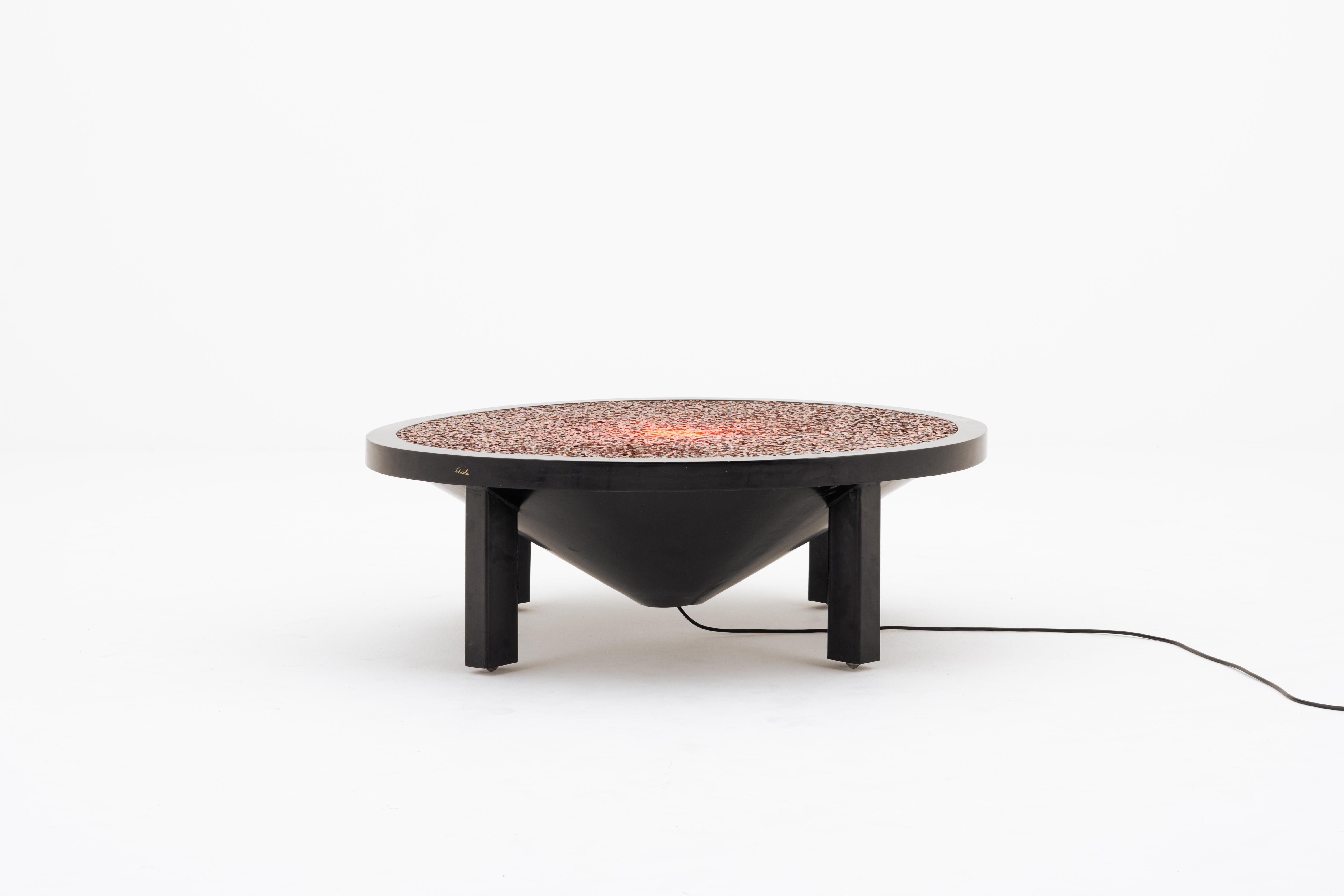 Ado Chale
‘‘Pastilles’’ illuminated coffee table, 1983 
Mosaic of cornaline agate stones and resin

H. 35 x 150ø cm

Son of a woodworker, Ado Chale spent his formative years in the Belgian countryside and began working with metal at a young age,