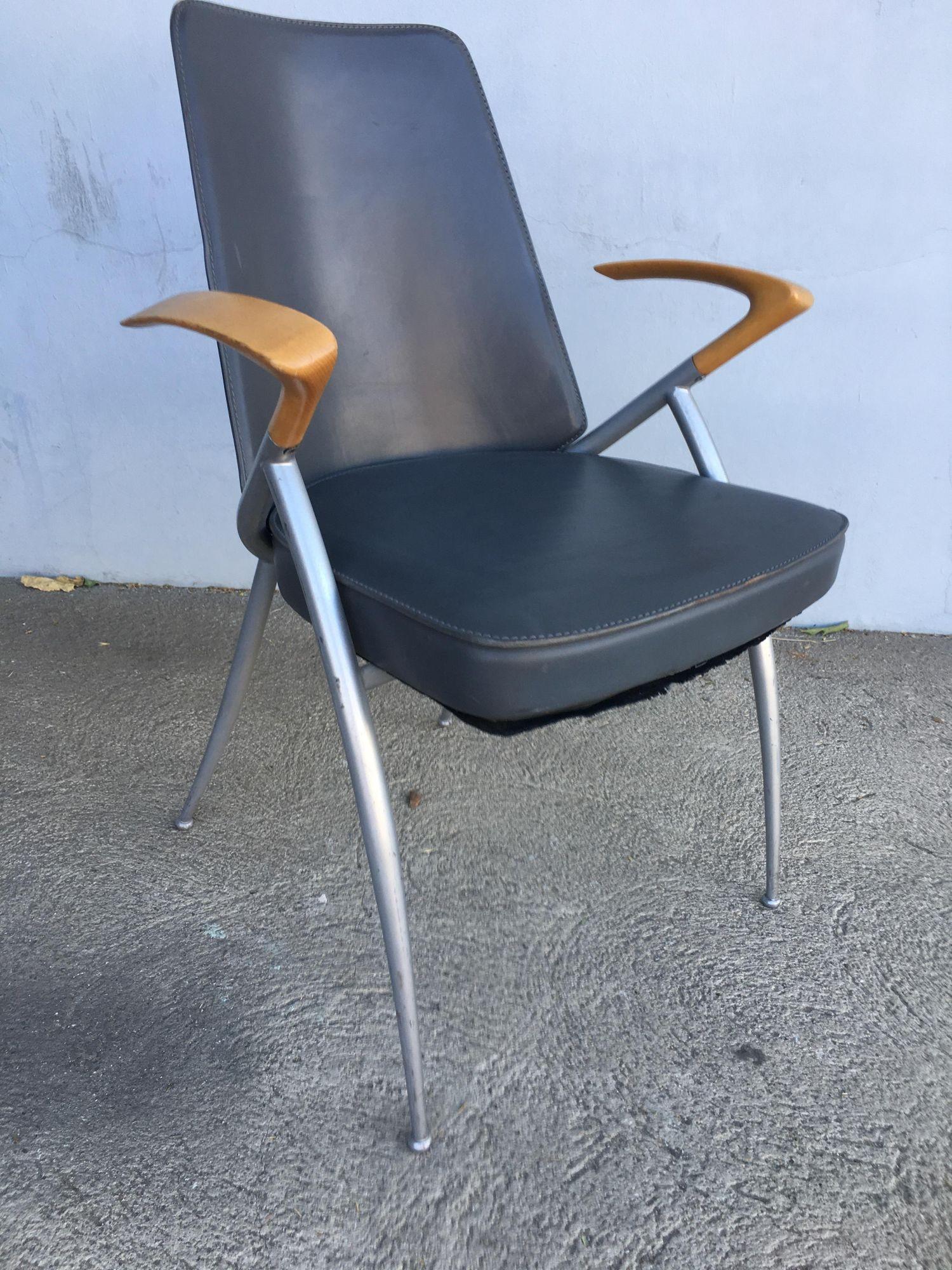 Modernist leather office chair (can be used as dining chair) with silver powder coat base and unique floating cherry oak wing back armrest.

