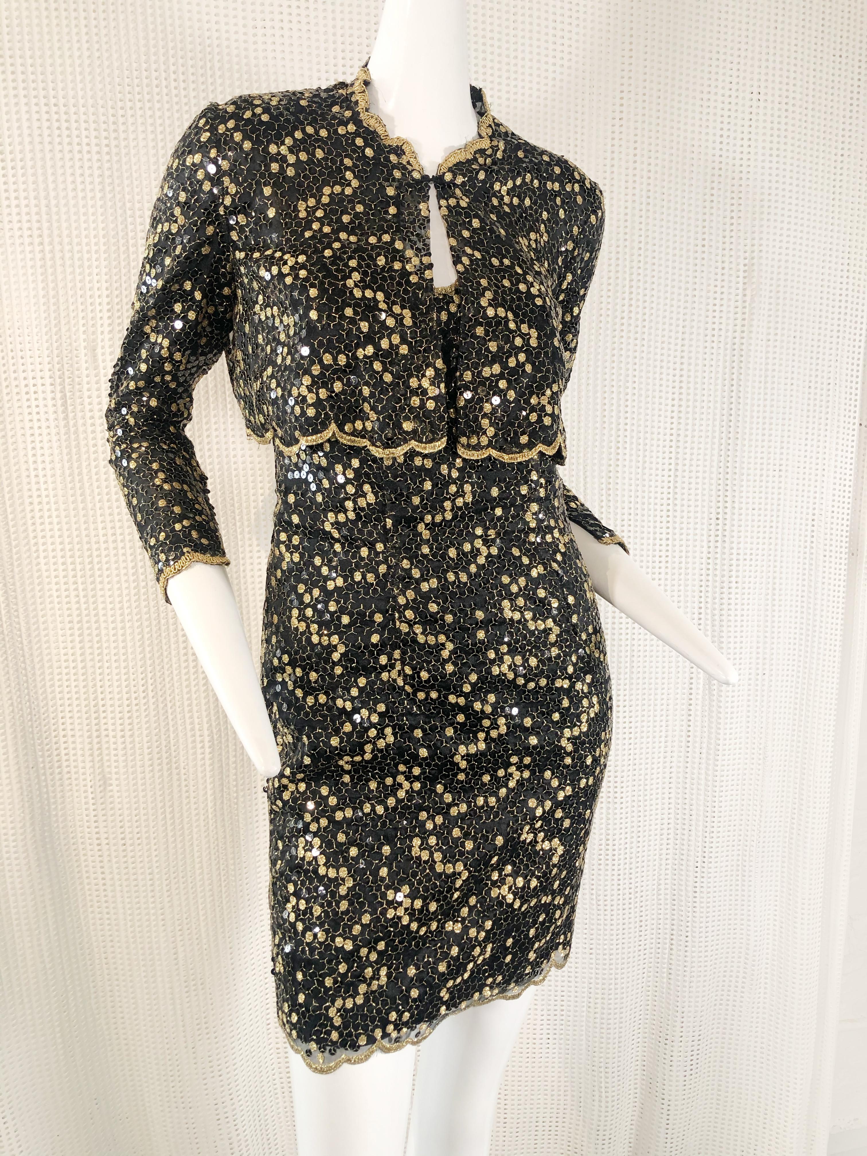 A sassy 1980s Pauline Trigere black mini dress with spaghetti straps and scalloped lace hemline.  Long sleeved bolero style jacket has the same scalloped lace hemline. Embellished all-over with scattered sequins and gold honeycomb embroidery. 