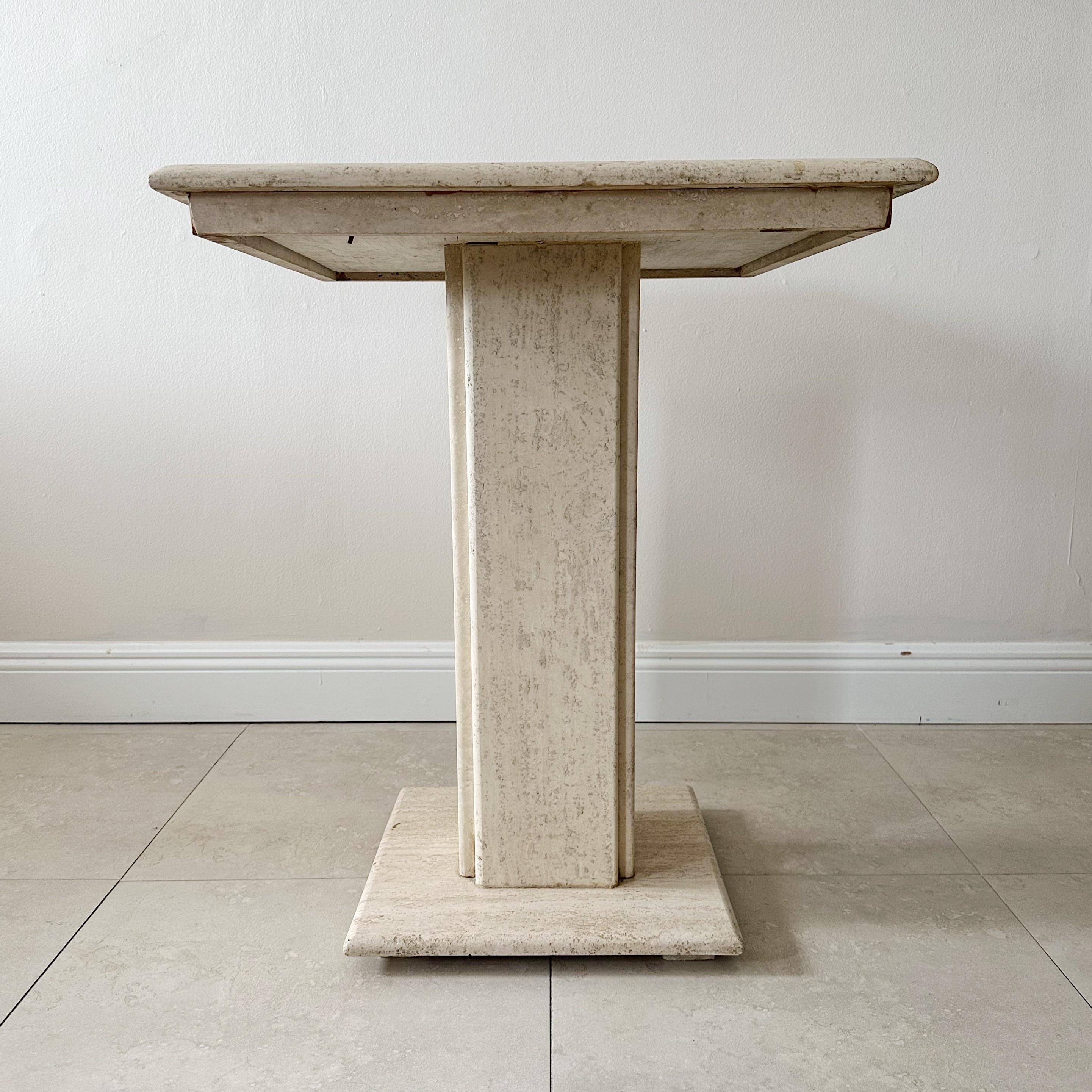 A 1960s single pedestal table made of travertine marble, featuring a square top with a chessboard inlay of black marble and Carrara marble. This exquisite piece of furniture showcases expert craftsmanship and timeless elegance. Perfect as a