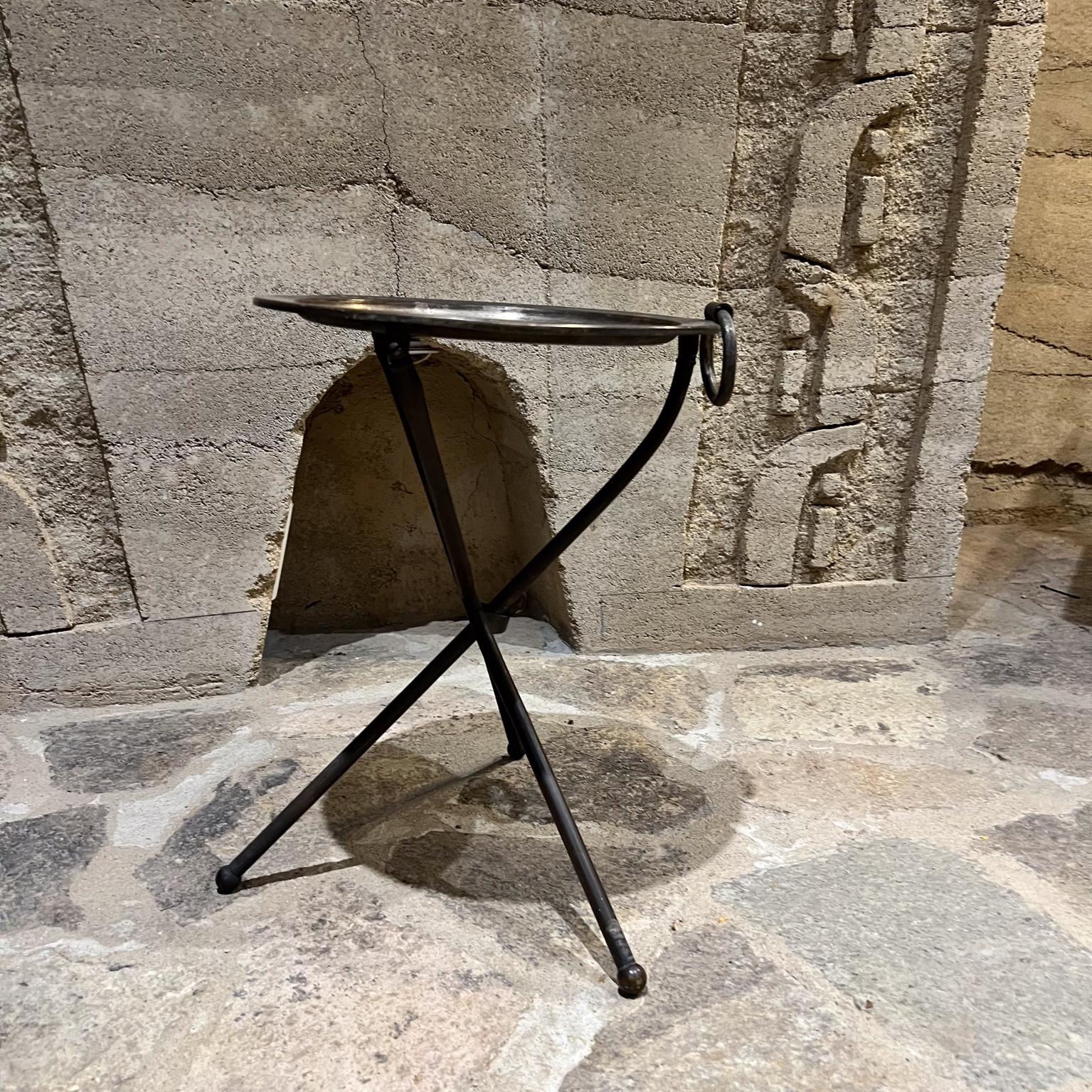 1980s Pedro Domecq folding service tray table tripod base Mexico
Silver plated brass. 
15 diameter x 16.75 
The table can be folded flat- has a ring for hanging
Original vintage unrestored condition. Patina present. Light fading on top.
Refer to