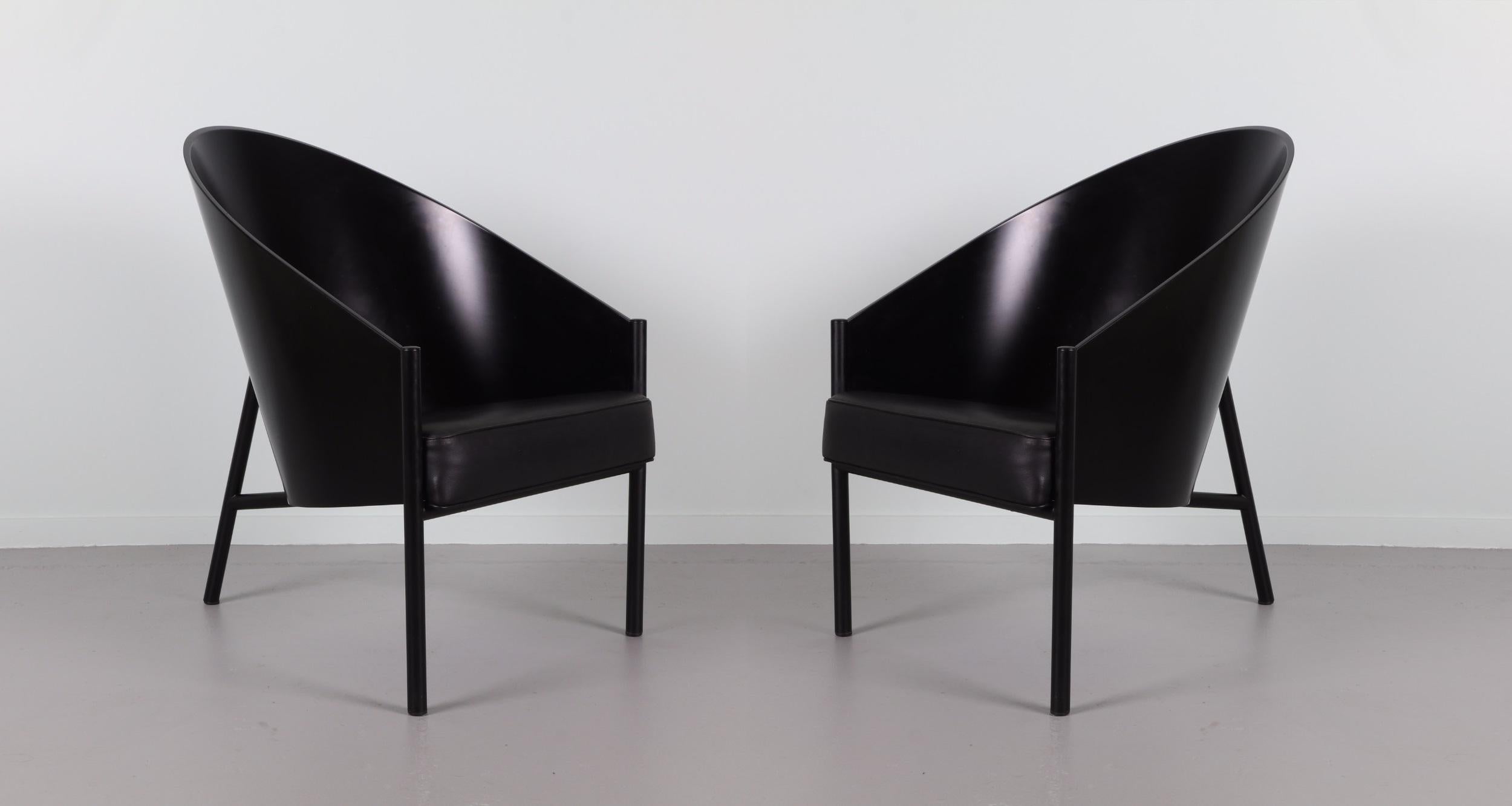 Pair iconic Pratfall lounge or easy chairs designed by Starck, circa 1982. The distinctive three-legged chair slightly larger, deeply comfortable wraps the sitter in a curve of black-lacquered beech. The chairs have a black metal tubular frame with