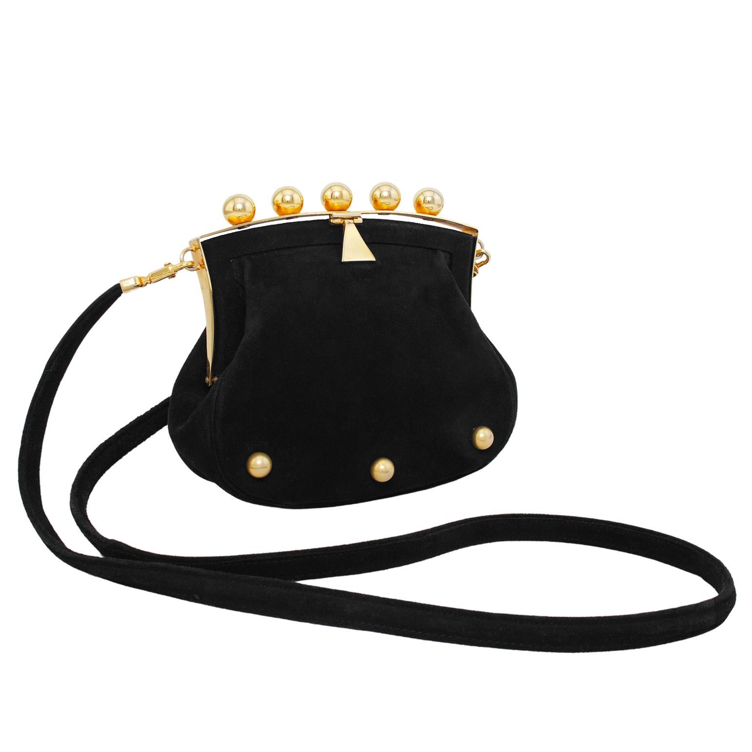 Very unique and interesting Phillippe Model frame style bag from the 1980s. Black suede with three gold tone metal studs across the bottom of the front. The top features a substantial gold tone metal frame with five gold spheres. Lever snap closure.