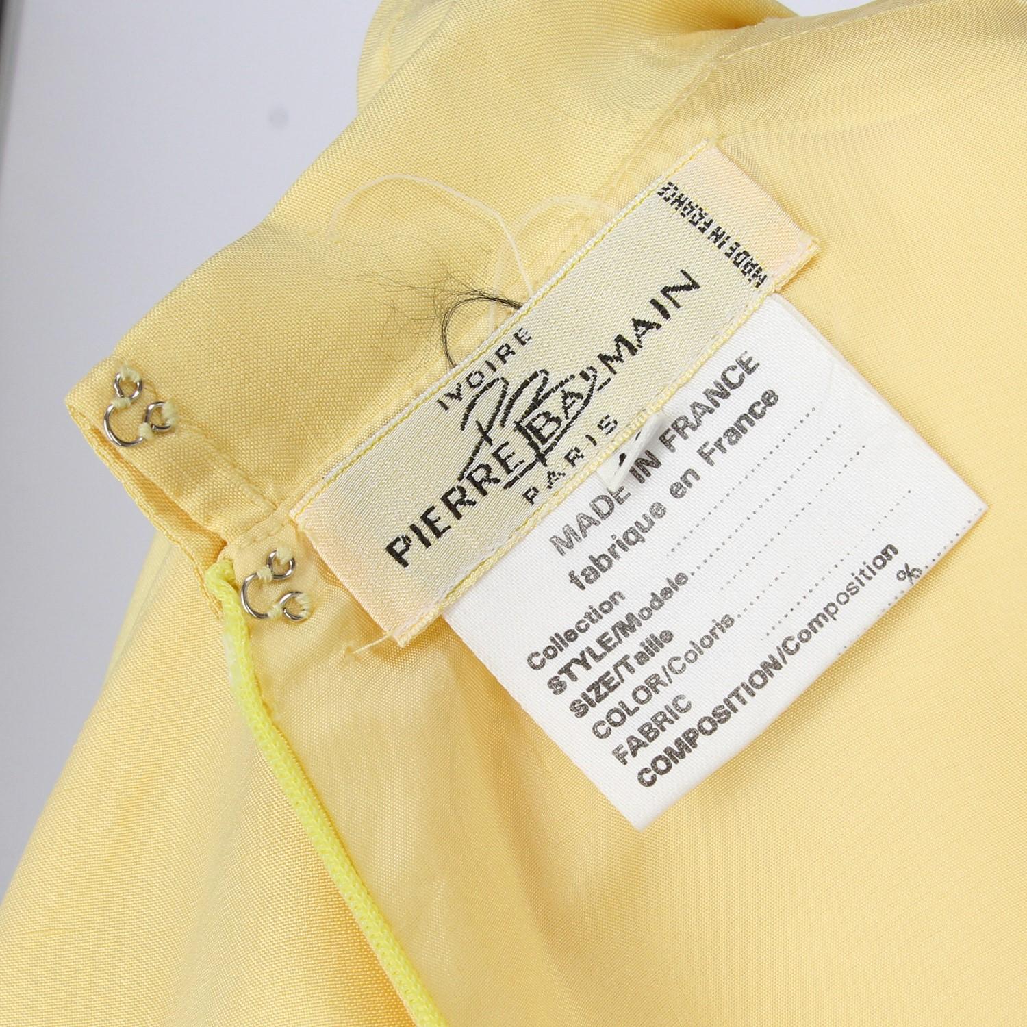 The elegant Pierre Balmain yellow silk straight cut dress features short sleeves and a classic collar. With back zip fastening and two front fake pockets, the dress is totally lined and in perfect conditions.
Years: 1980s  

Made in France 

Size: