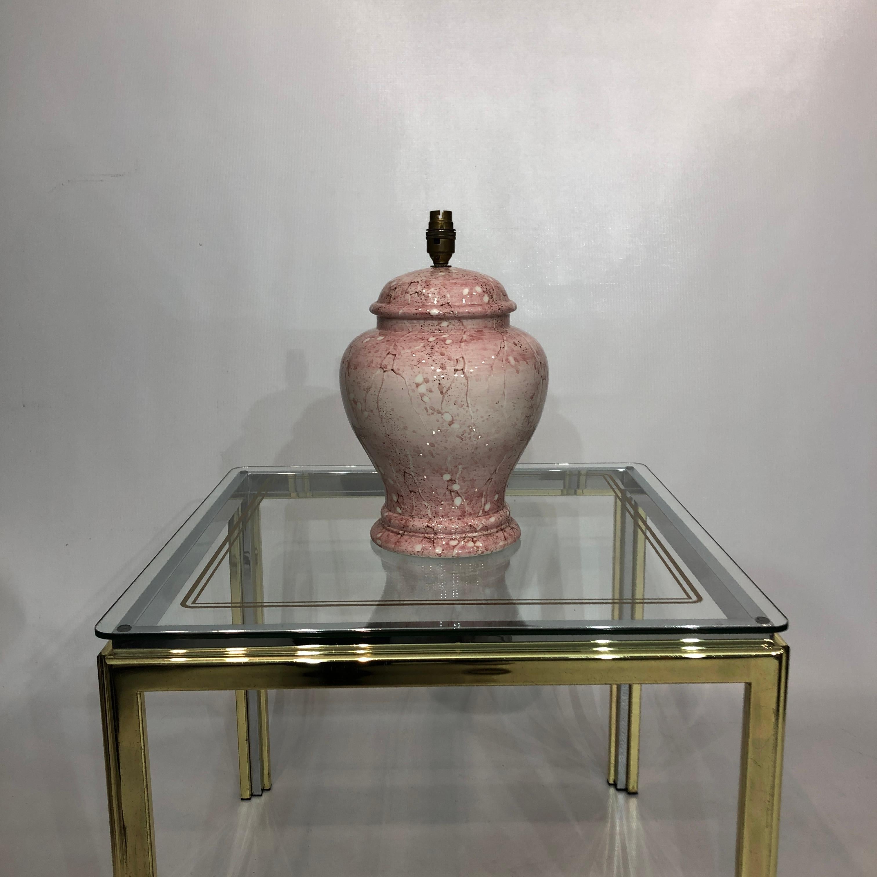 A beautiful pastel pink/cream ceramic urn-shaped lamp, with a crackled splashed marbling effect. This lamp has shades of neoclassicism, with its almost crack-like pattern down the side of the base.

This table lamp originated in Italy in the 1980s,