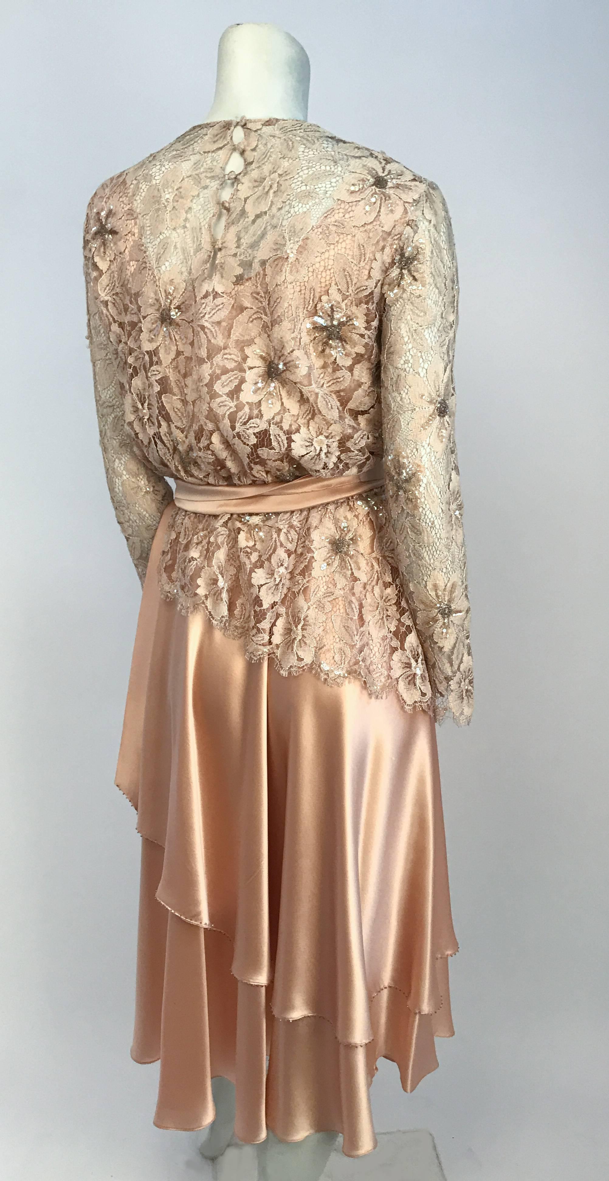 1980's Pink Lace and Satin Dress. Lace and Satin dress with iridescent sequins and beads. Double tiered asymmetrical skirt with beaded hem and French seams. Buttoned back closure and elastic waist. detachable waist sash.
