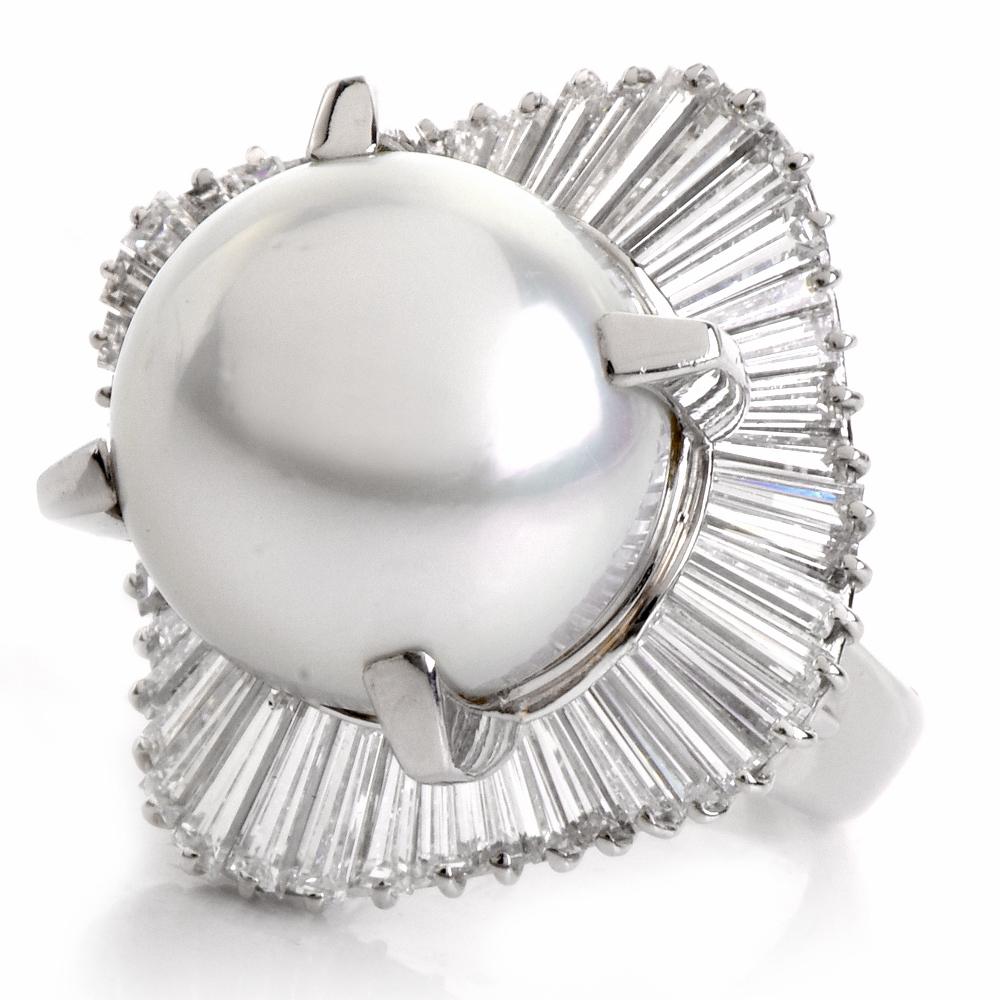 This captivating ballerina cocktail ring is crafted in solid platinum and weighs approximately 19.1 grams. It is centered with a lustrous south-sea pearl approx. 14mm in diameter, of silver white tone color. The ballerina pattern is composed of