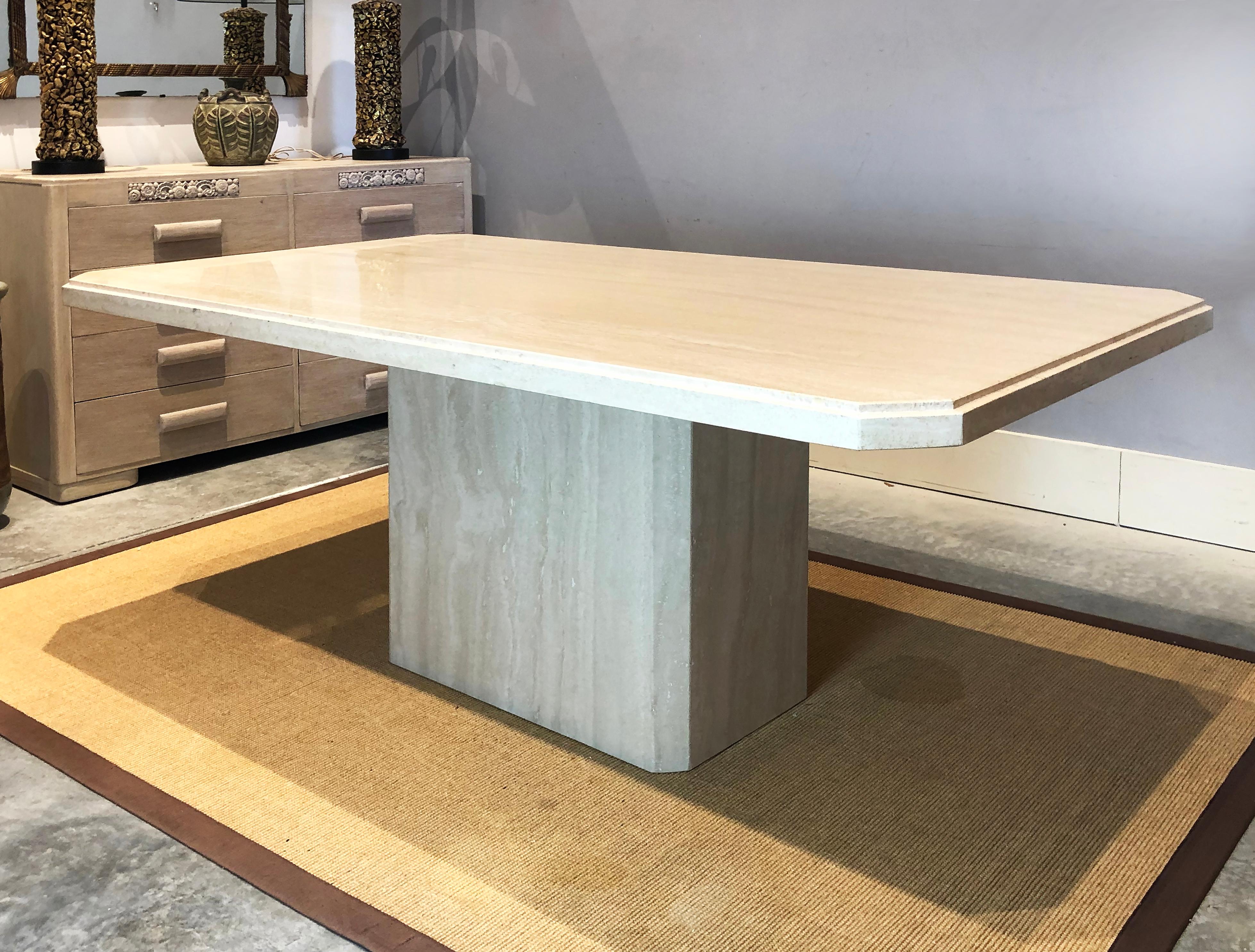 1980s polished travertine pedestal dining table by Ello

Offered for sale is a 1980s polished Travertine Dining Table made in Italy by Ello. This rectangular solid slab table is supported by a large travertine pedestal base. The top has blunted