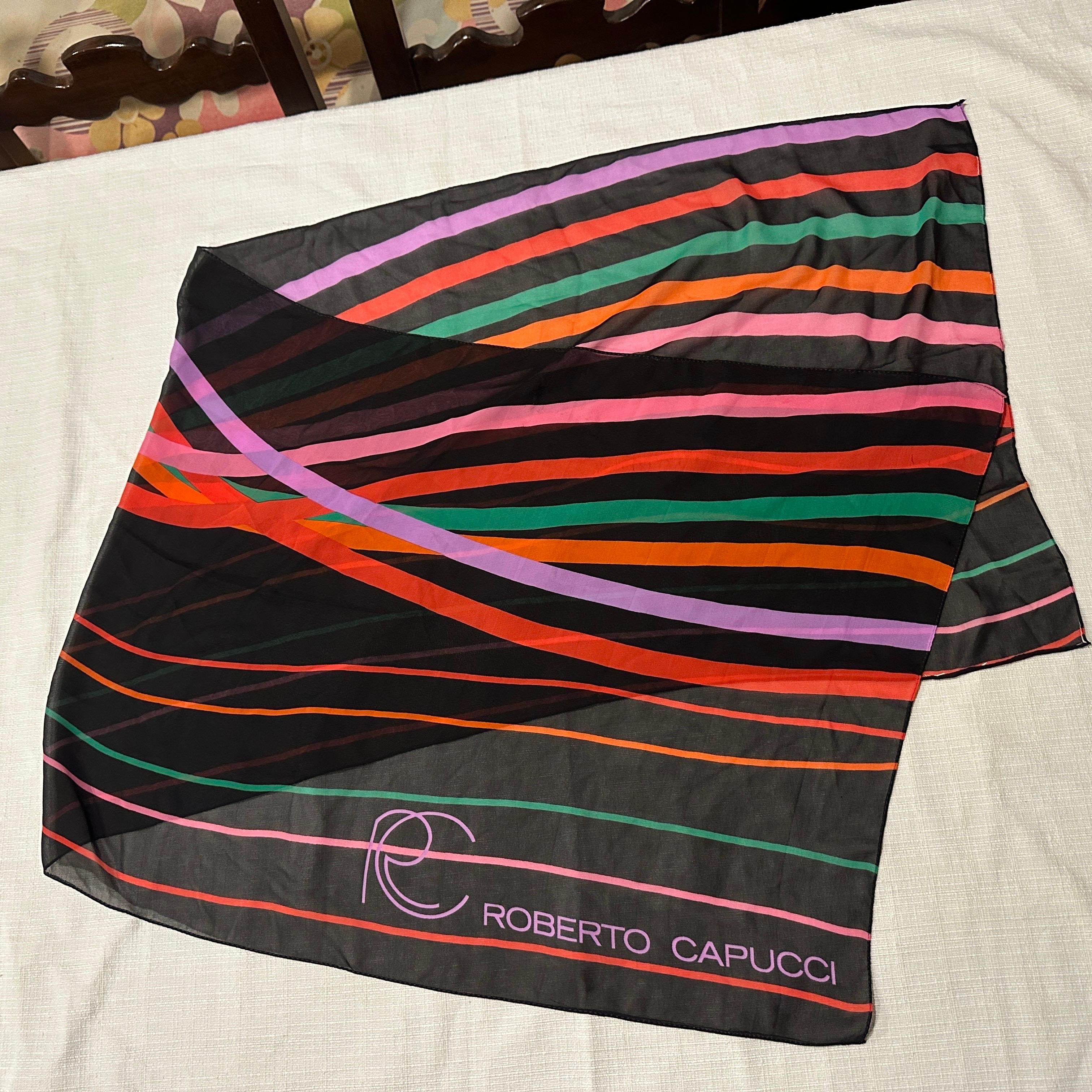 This is a stunning 1980s Italian long silk scarf by Roberto Capucci, known for his vibrant use of color and elegant design. The scarf features a dynamic polychrome pattern with bold diagonal stripes in vivid hues such as orange, pink, purple, green,