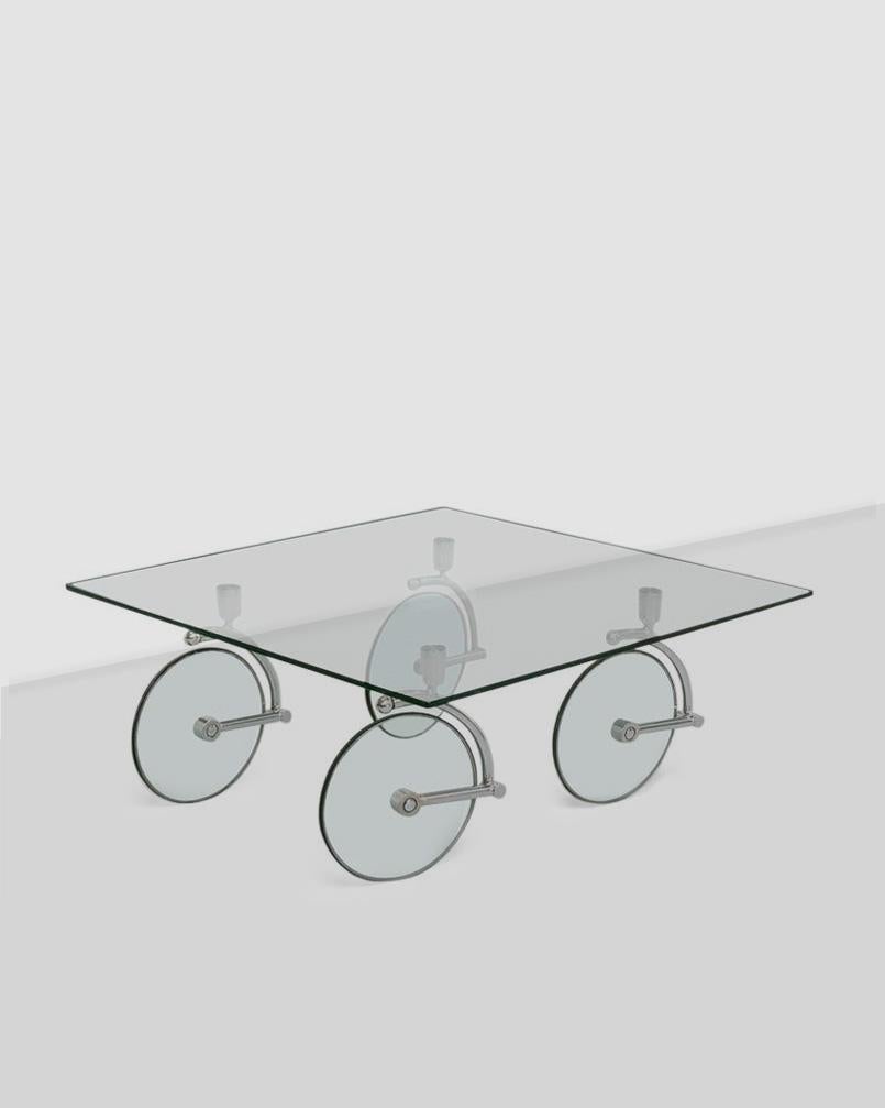 1980s Postmodern square glass coffee table on 4 glass and chrome wheels after Gae Aulenti for Fontana Arte, Italy. Wheels swivel 360 degrees and can be detached from the glass top. 

In good vintage condition and structurally sound -- please expect