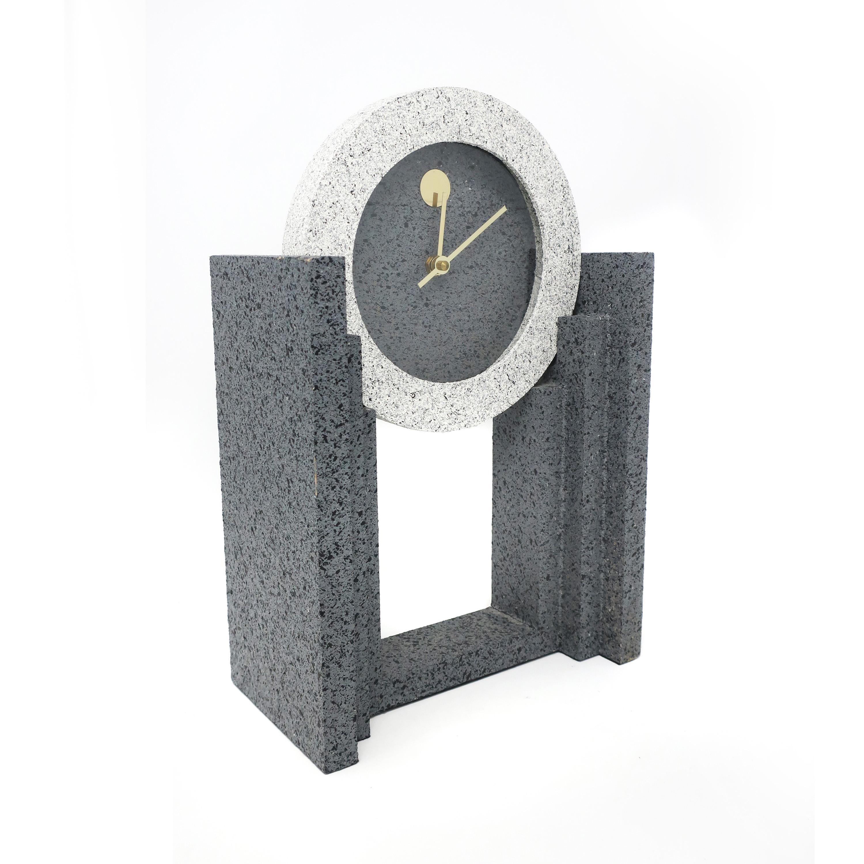 A vintage 1980s postmodern textured mantle clock by Empire Art Products in various shades of spelled gray with brass hands. In very good vintage condition and works well.

Measures: 9.5