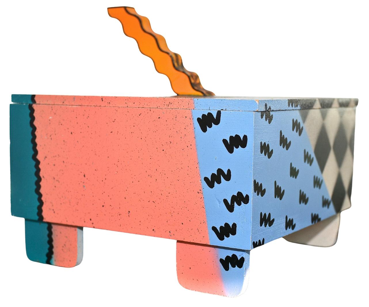A fantastic postmodern Memphis style handmade, hand-painted wood box with distinctive rounded flat feet and sculpted wavy handle by artist Hollis Fingold. The inside of the box has a radiant blue fabric padding airbrushed 
with a black checkerboard