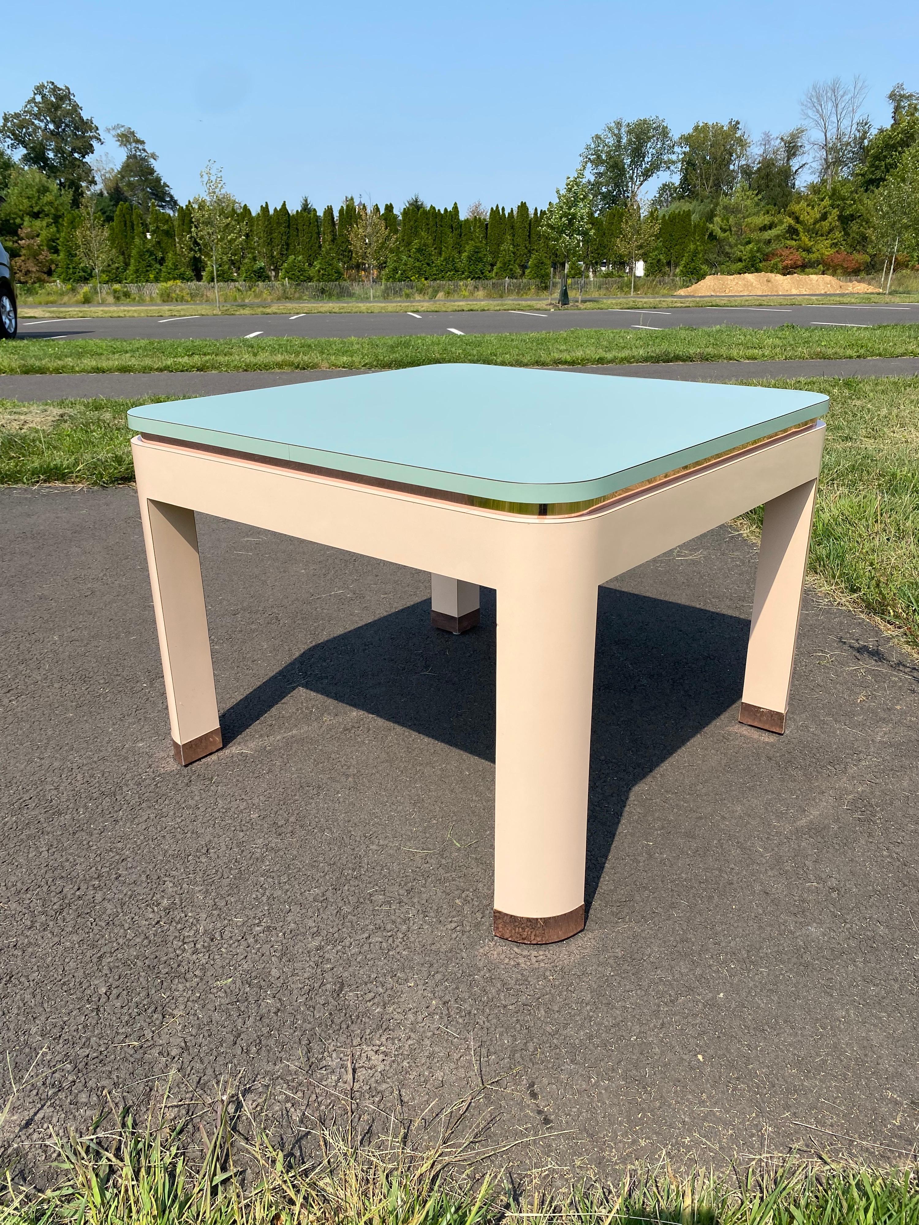 Fabulous 1980's Postmodern Parsons square side or end table featuring pink, turquoise, and reflective rose gold trim detailing. This large Memphis style table can also be used as a tall center coffee table.