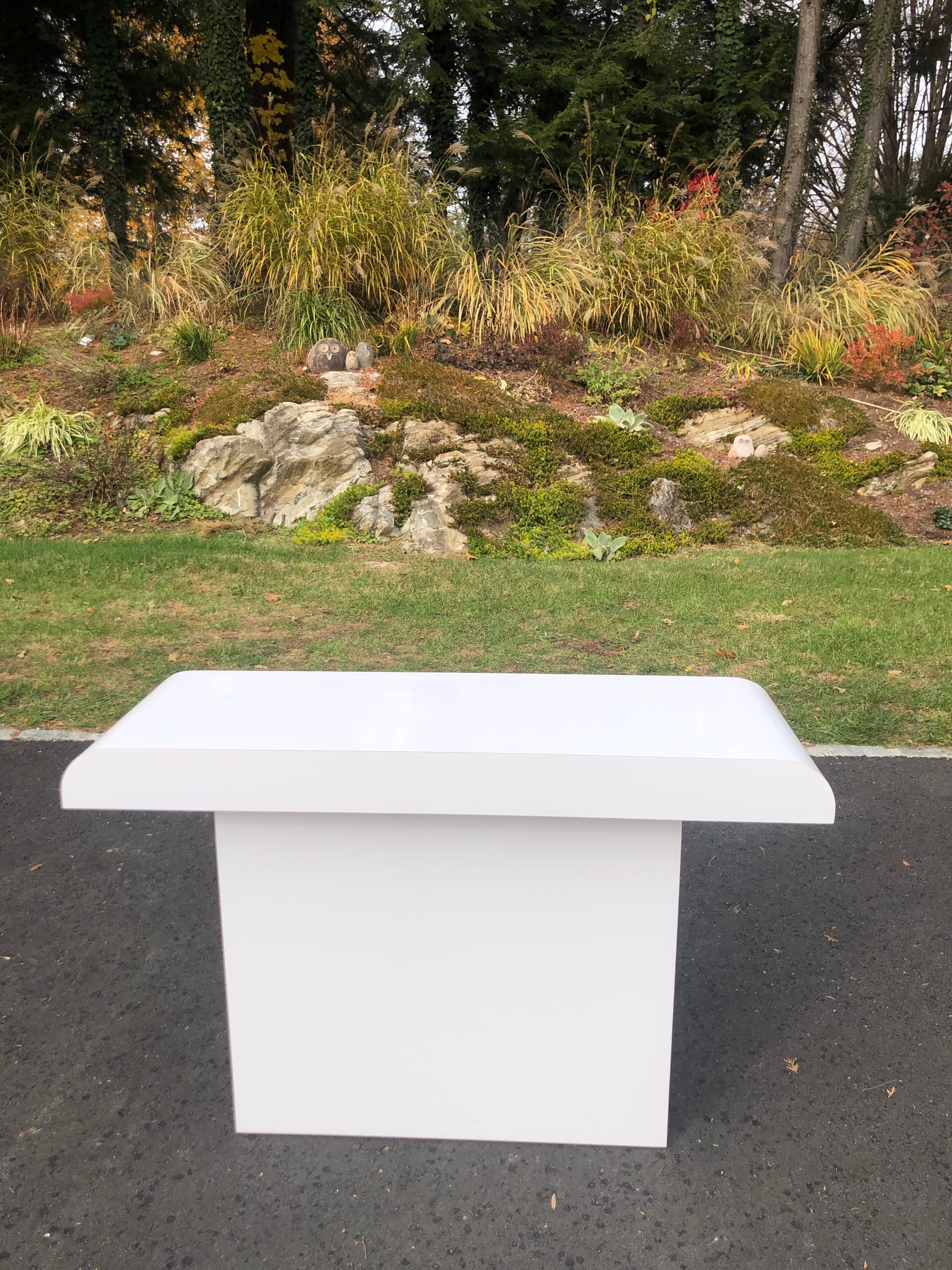 1980's Post Modern white laminate console table. Mint condition. Clean, minimalist lines.
Perfect for an entry way, dressing room / closet or use as a sofa table. Nice high gloss white finish,