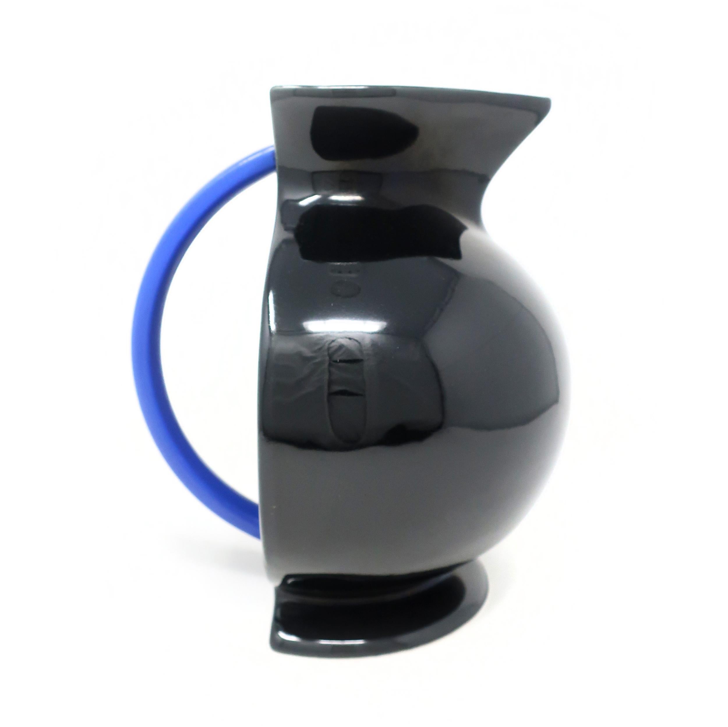 Stunning postmodern ceramic pitcher from the Hollywood collection designed by Marco Zanini for Flavia Montelupo/Bitossi. The black body, rounded blue handle, and flat back show a clear influence from the Memphis group designers, of which Zanini was
