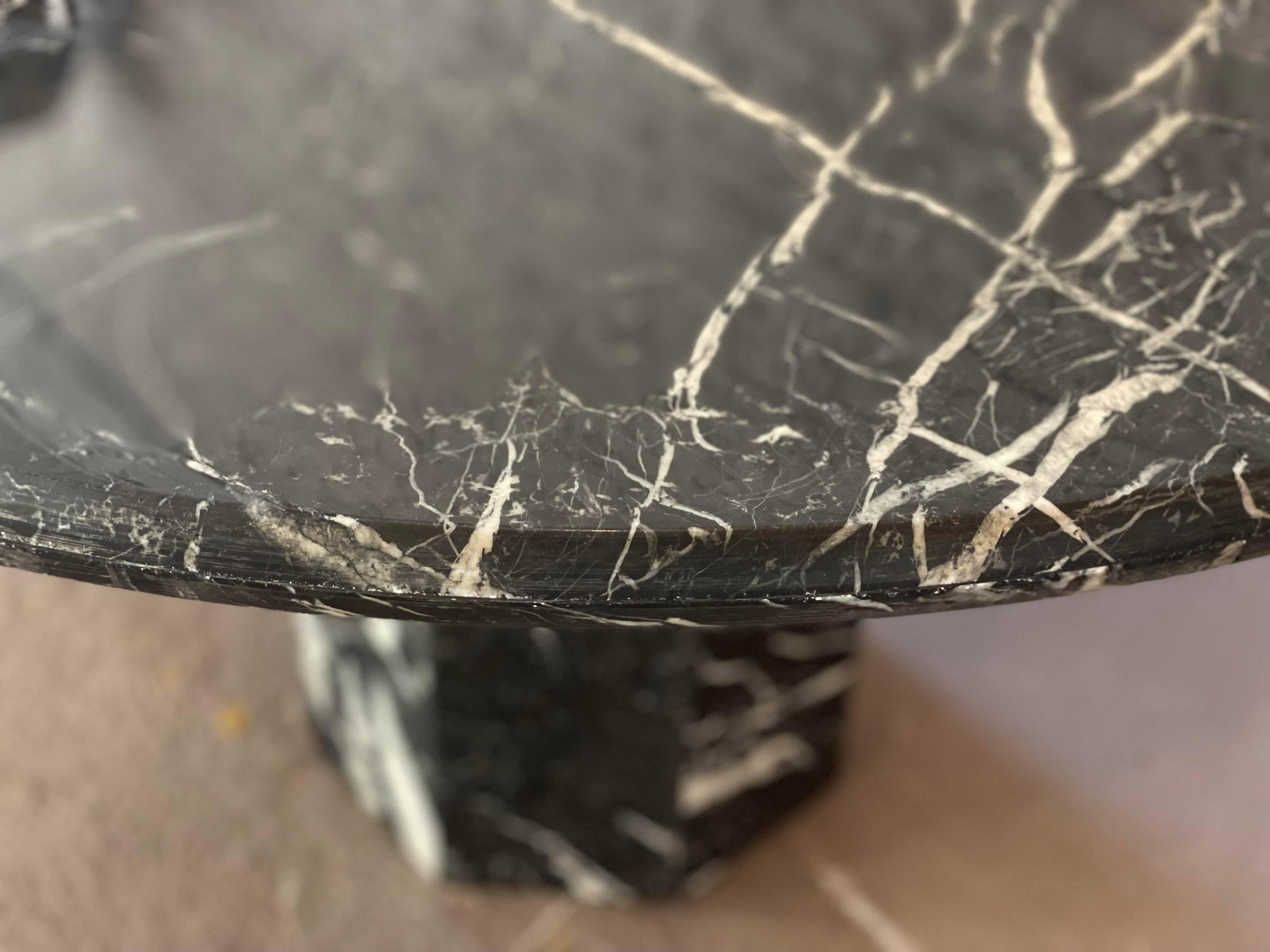 Beautiful black marble table. Perfect size for 4/5 chairs or an entry way table. The base has lots of drama while the top is calmer.

Dimensions: 49