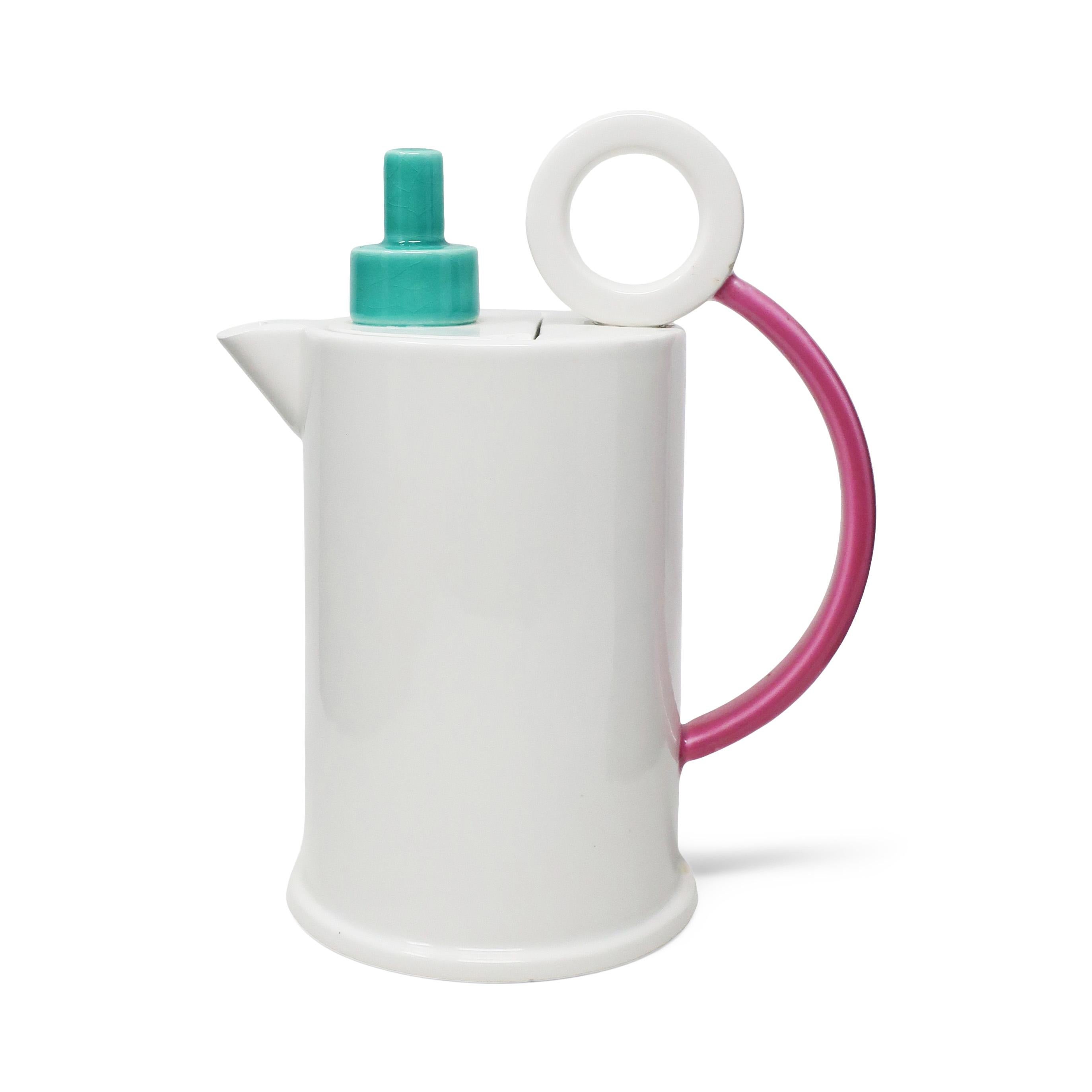 Stunning postmodern ceramic tea or coffee pot from the Hollywood collection designed by Marco Zanini for Flavia Montelupo/Bitossi. White body, rounded pink handle, and stacked teal top show a clear influence from the Memphis group designers, of