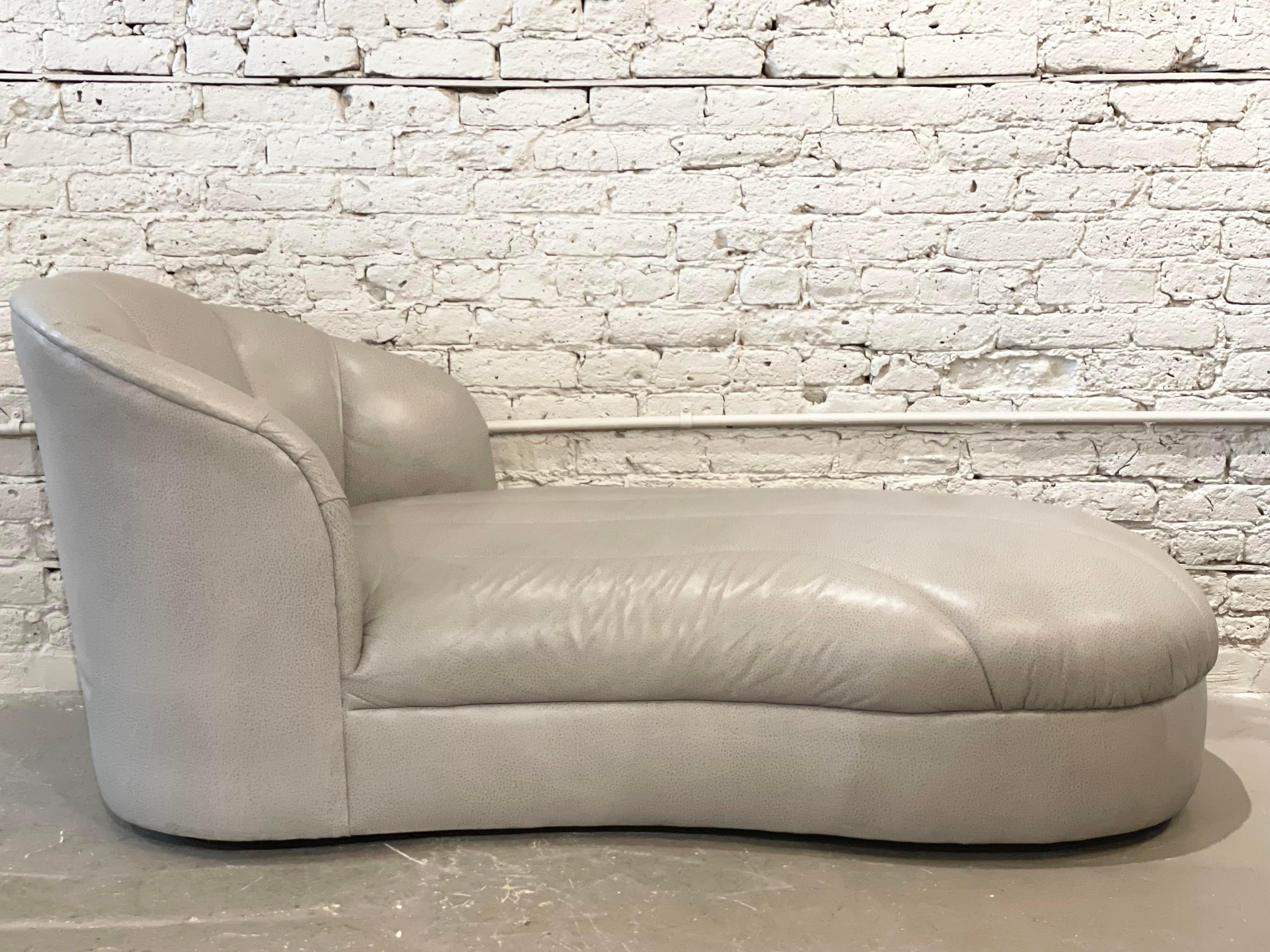 Very chic clean lined and slim profile chaise lounge. It’s is slightly curved too making this extra comfy. The original vegan leather upholstery is in excellent condition and can be used as is or redone in your favorite fabric.