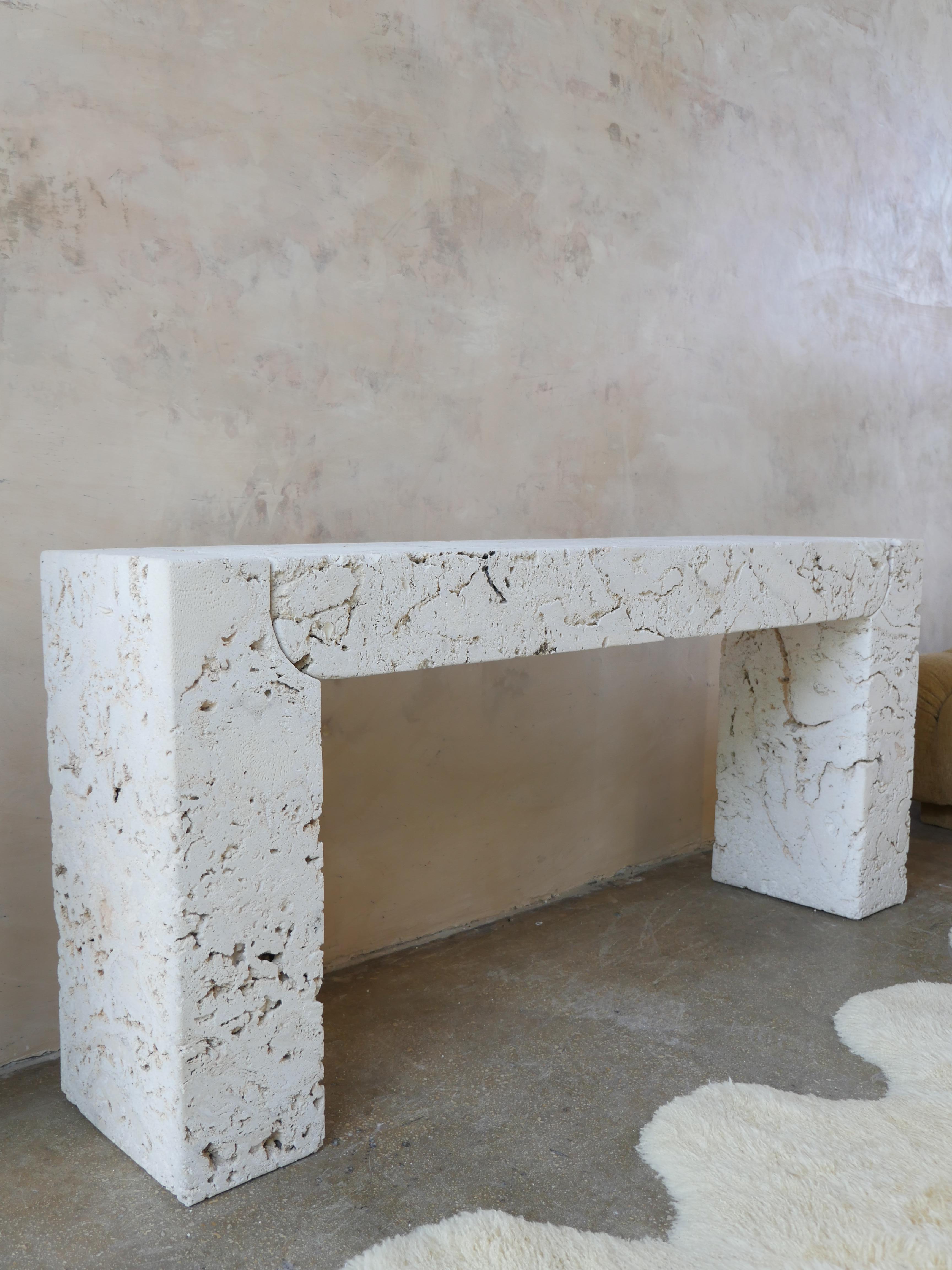 Monumental 1980's three-piece, post modern coral stone console table. With its unique shape and textured calcified organisms, this beautiful coral console is sure to make a statement in any room it's placed. The table is comprised of two bases, and