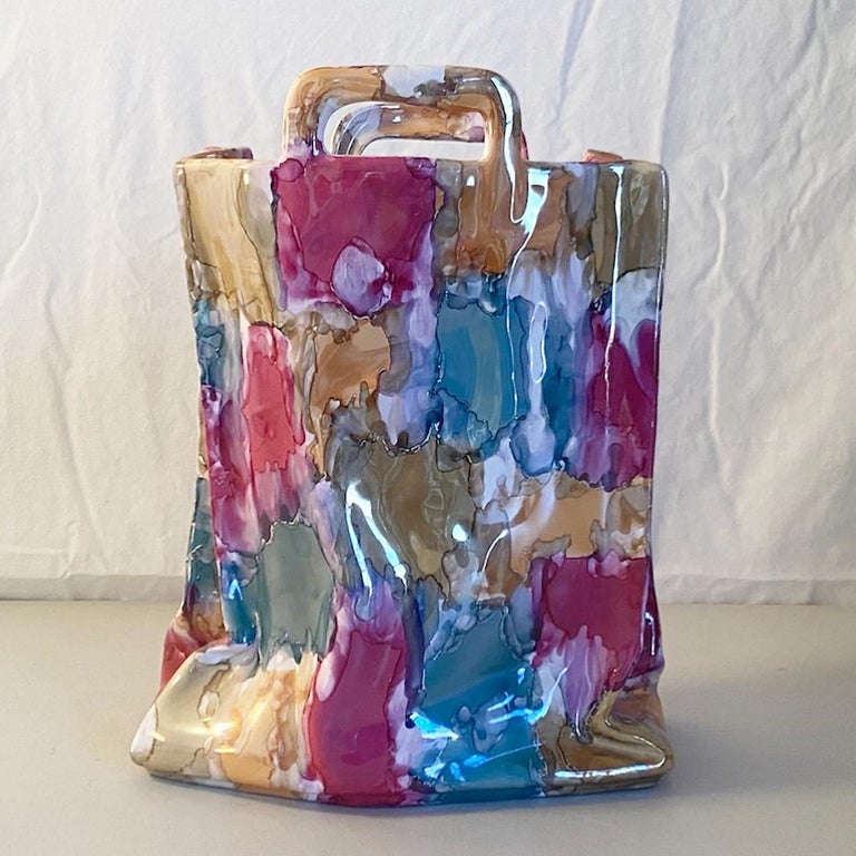 Exceptional Italian postmodern ceramic vase by Deruta Nazareno Picciotti. Features a multicolor finish over a sculpted handbag.
