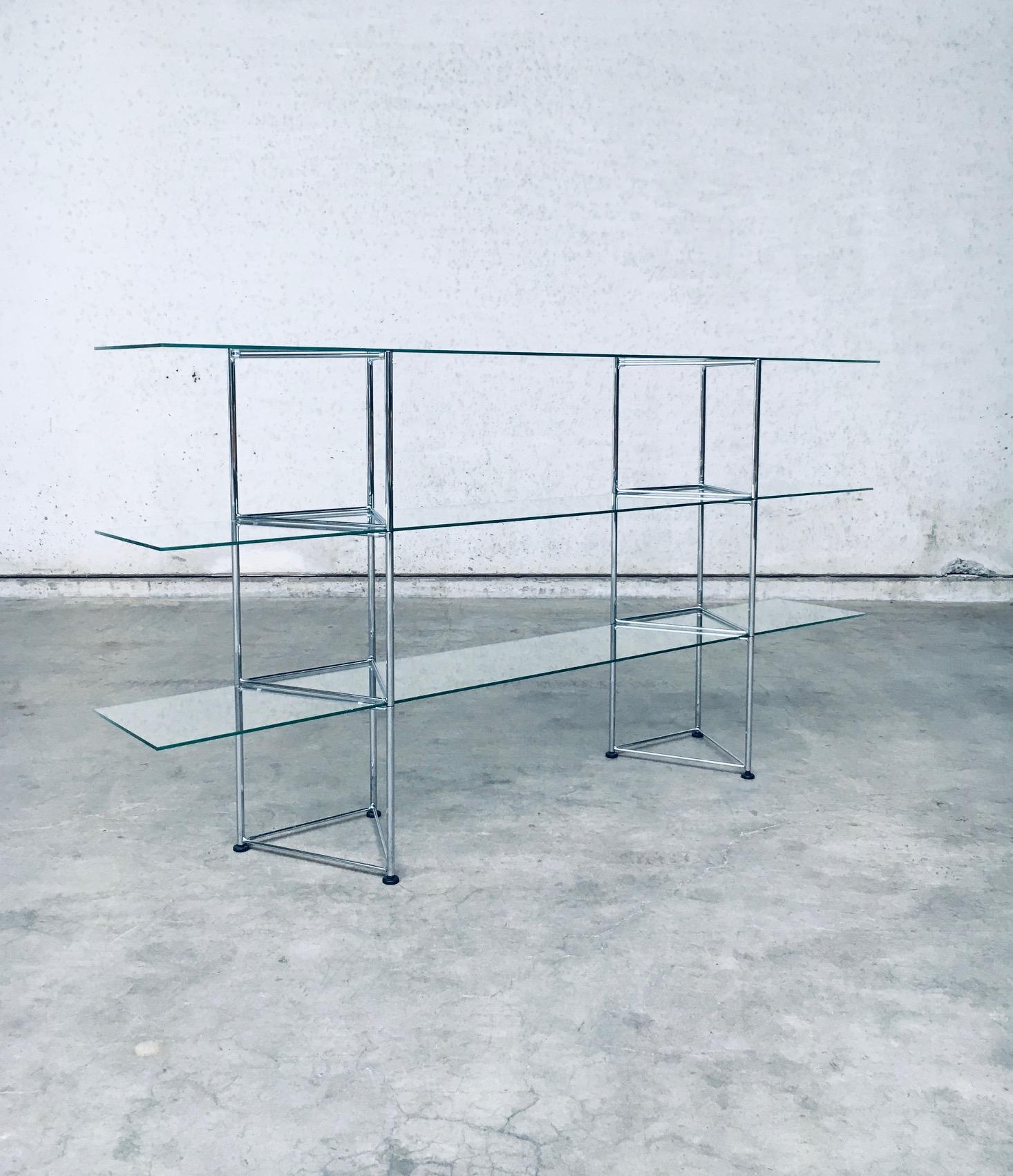 Vintage Postmodern Design Slender Glass & Metal Wall Rack / Display Shelves. Made in Italy, 1980's. Three long glass shelves with triangular shaped metal constructed supports. Airy and light in design, typical for this period. This comes in very
