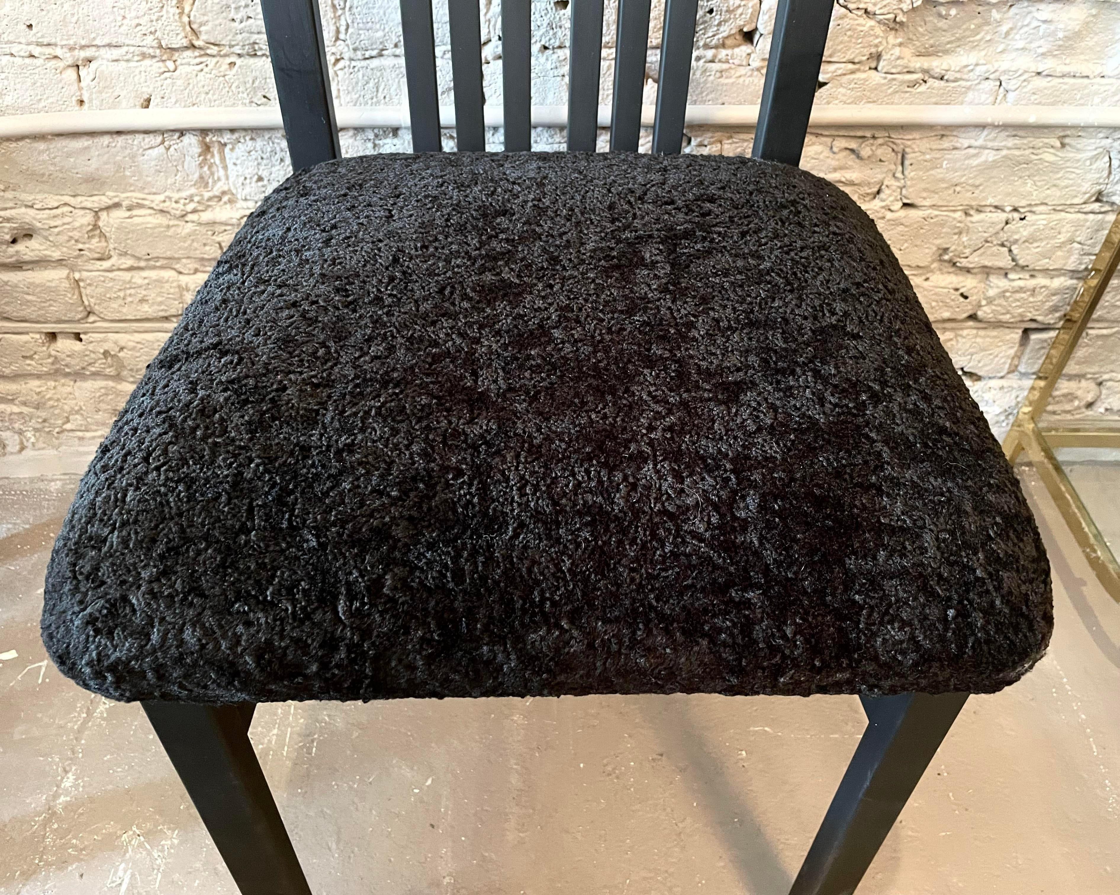 Gorgeous and completely restored dining chairs. We painted the wood with a fresh coat of soft black paint and fluffed up the seat cushions with black faux Persian lamb upholstery.