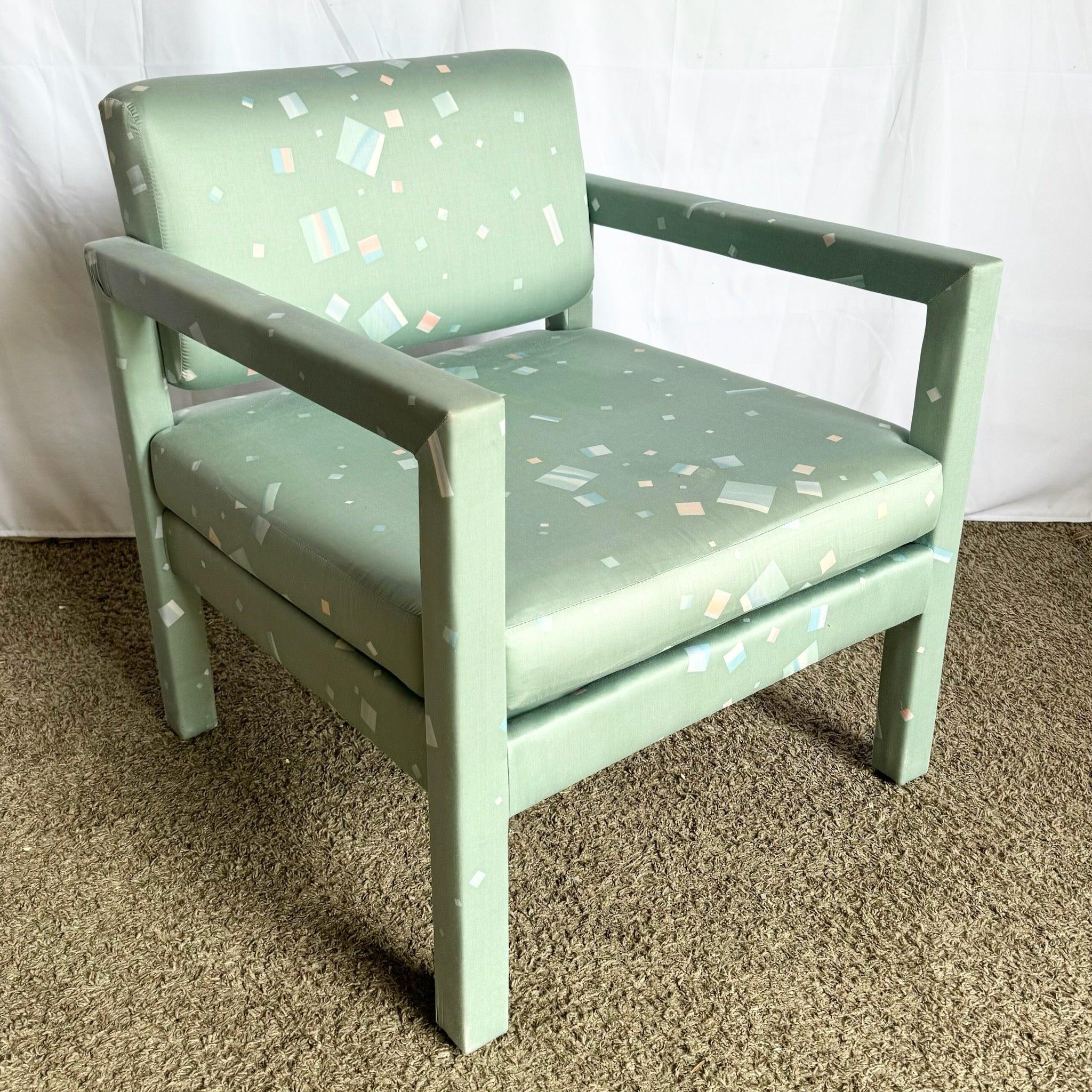 1980s Postmodern Parsons lounge chair featuring a boxy frame and green fabric with abstract pastel blue and pink geometric patterns, perfect for eclectic interiors.
 
 Minor wear around the arm rests and edges as shown in the photos.