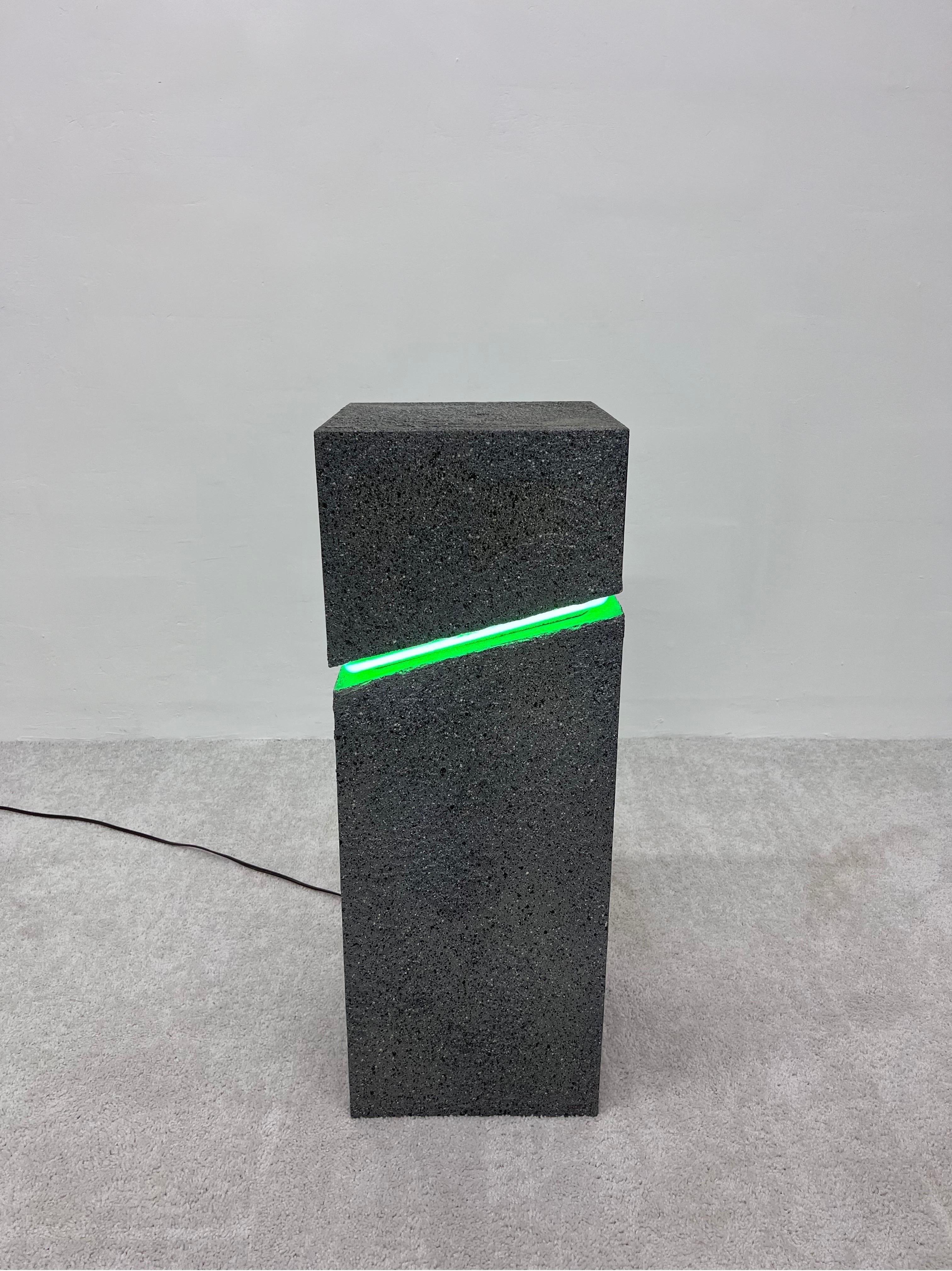 Postmodern 1980s black and white splatter painted textural pedestal with green neon lamp.