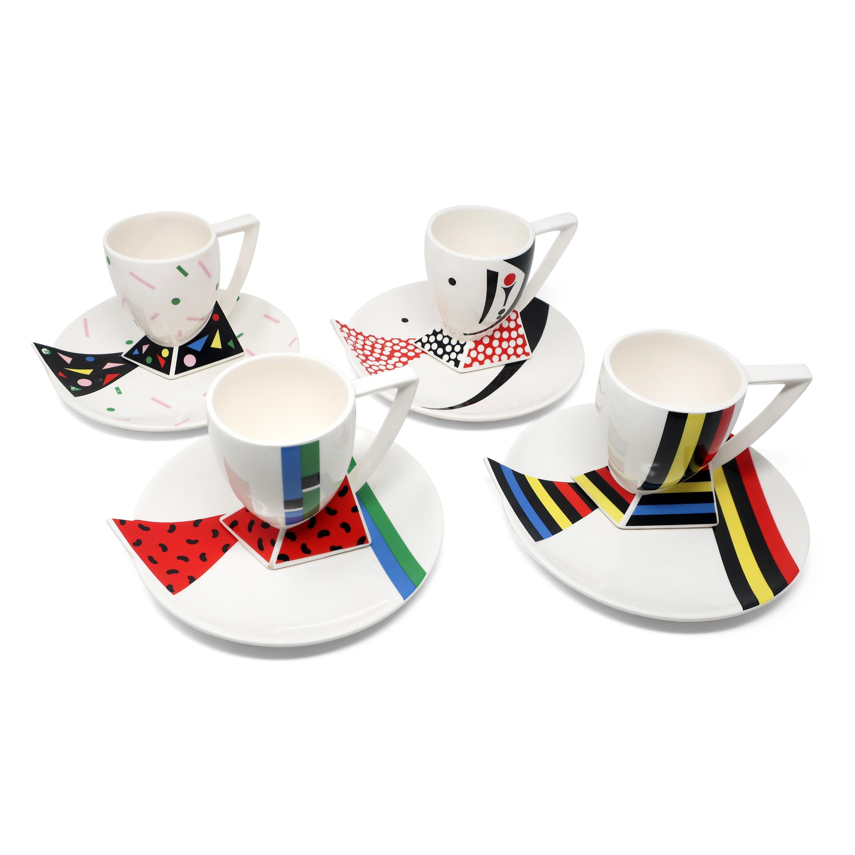 A set of four ceramic mugs and four ceramic plates in the Alpha 3 pattern for Kato Kogei's Fujimori Collection. As Art Director for Kato Kogei Ceramics, Fujimori oversaw the design and distribution of his signature line. These pieces are perfect