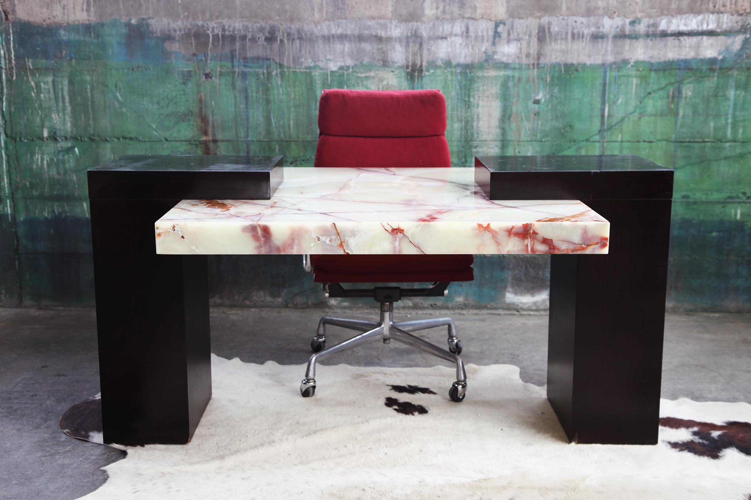 Incredible 1980s Postmodern Marble designer desk. Great for use as an executive desk or a two sided desk. The black pieces supporting the marble writing surface work well to hold desk lamps. The design is stunning. Original 1980s showroom price tag
