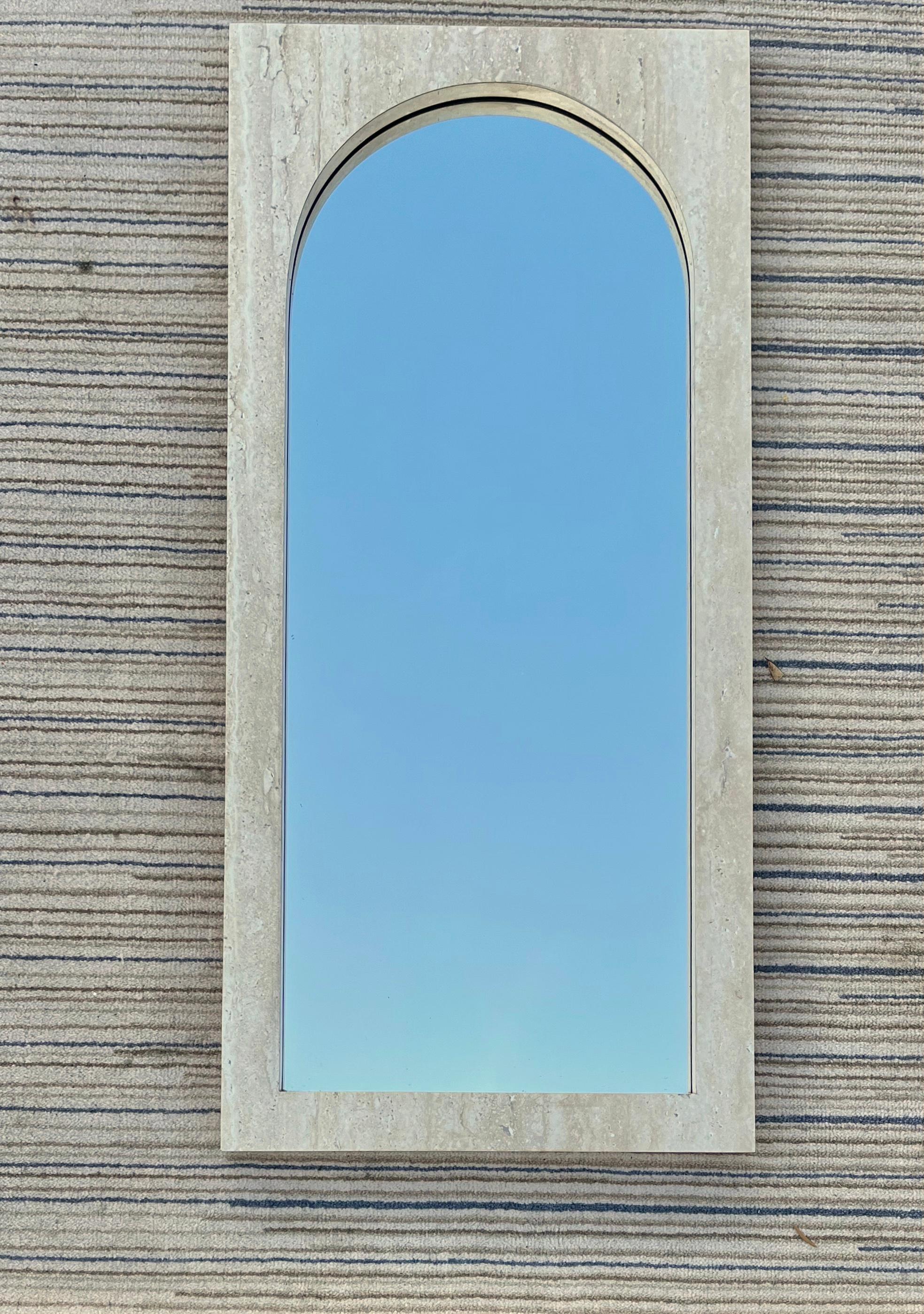 Large Vintage Postmodern marbleized wall mirror. Circa 1980s
Features a minimalist fully faux stone / marbleized pattern laminated frame with an arched top mirror. 
In excellent near mint original condition with very minor signs of wear and age.