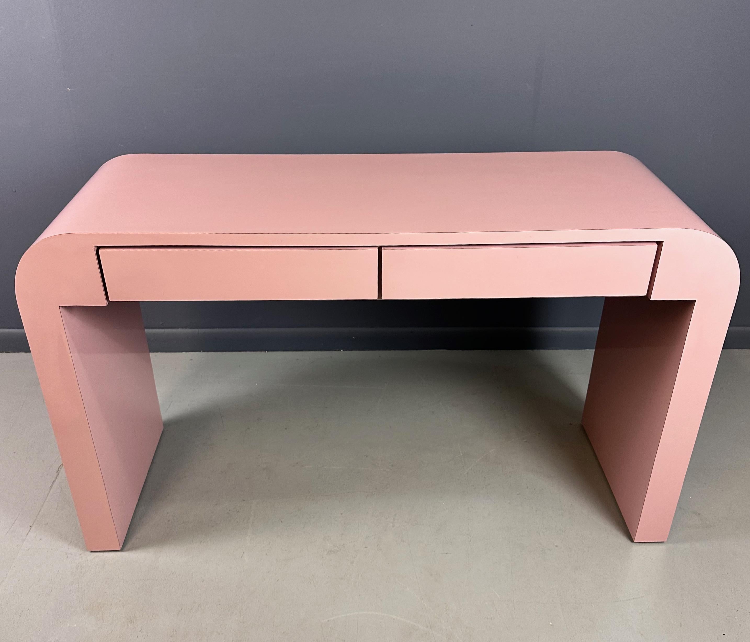 Add some playful charm to your workspace with our 1980s Mauve Waterfall Laminate Desk, the epitome of eighties design complete with two drawers for storage and a custom bench to sit on while you work, this desk is a perfect blend of style and