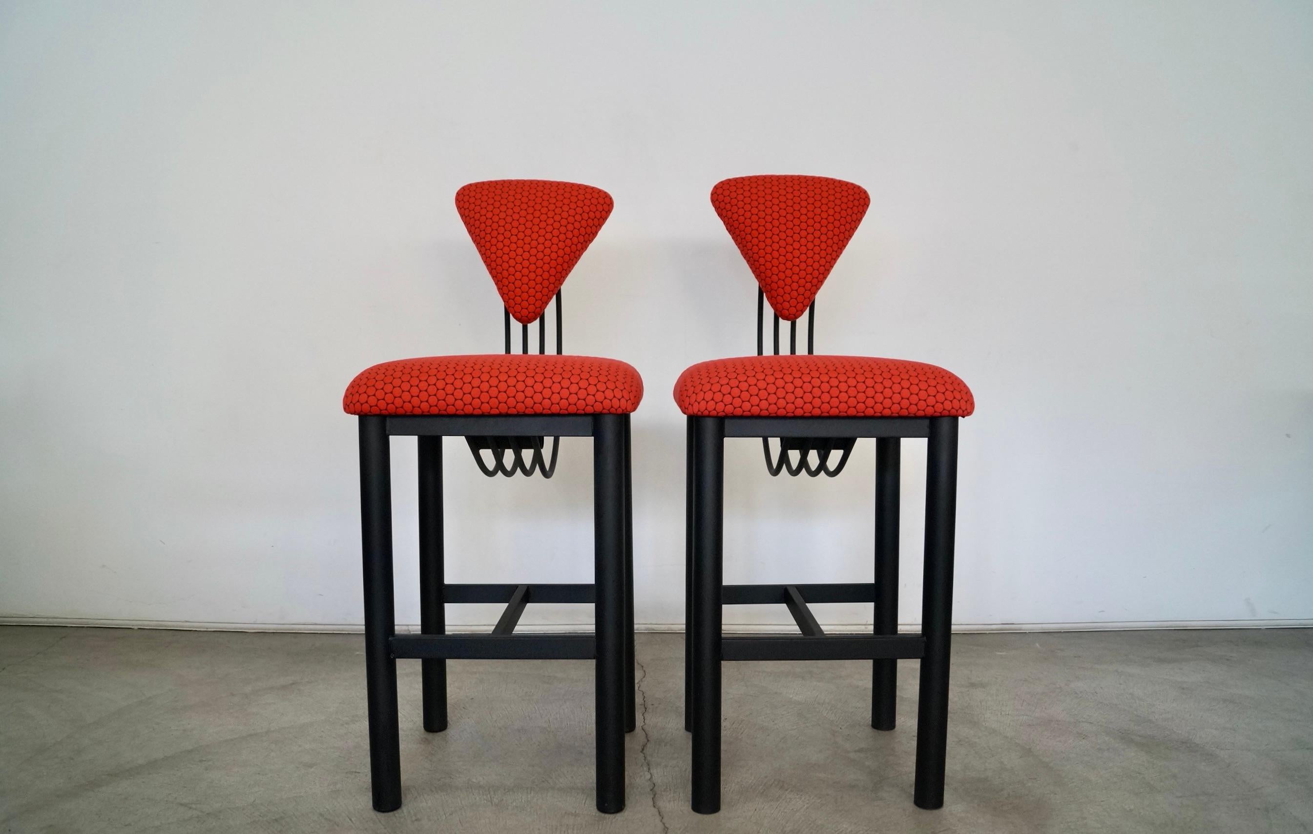 Vintage pair of Post-modern barstools for sale. Memphis style from the 1980s, and in excellent condition. They have a black metal frame and have been professionally reupholstered in new designer fabric and foam. We chose Designtex's Loop to Loop