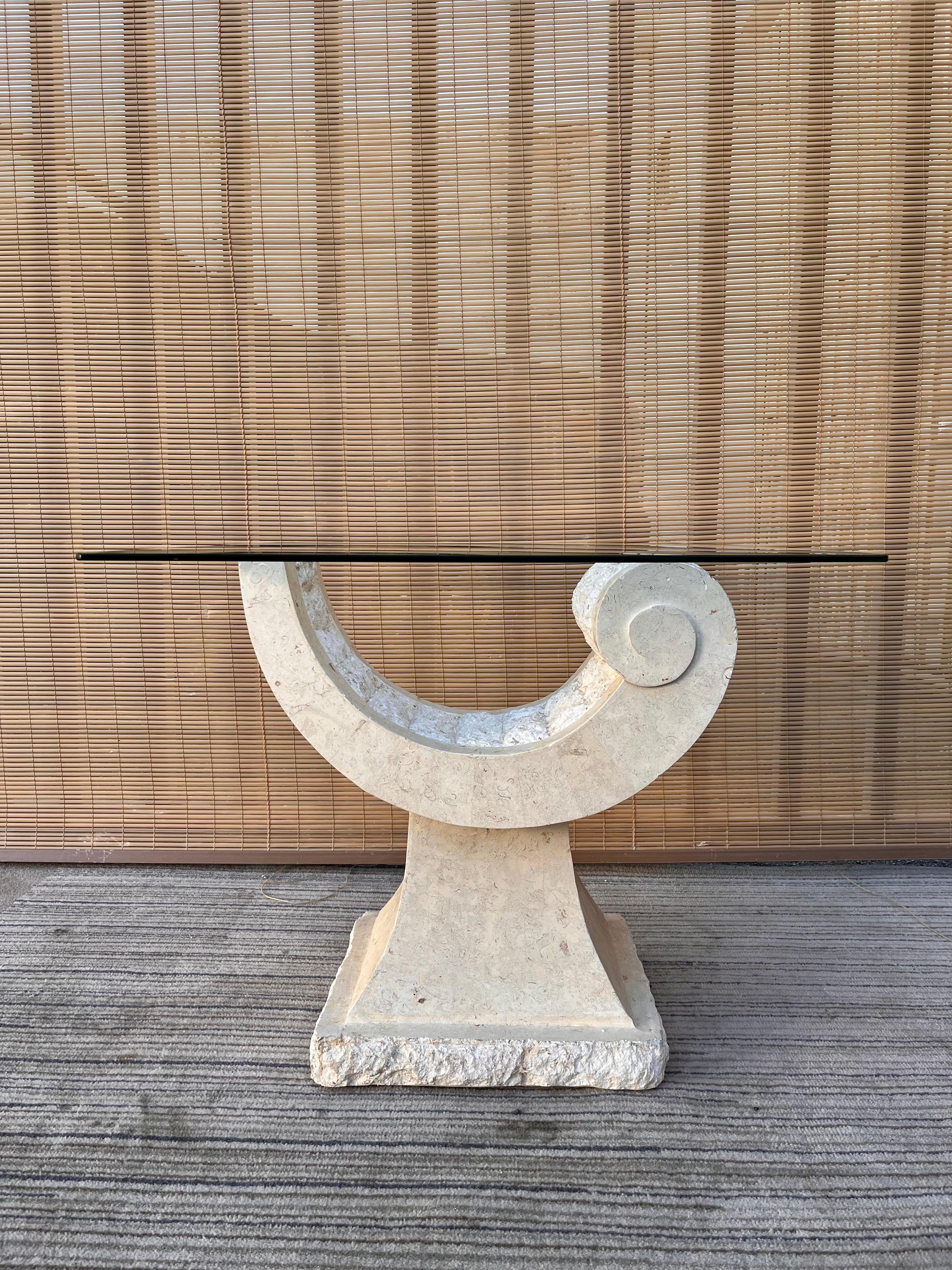 Postmodern sculptural natural mactan stone accent / end table with square glass top. Circa 1980s. 
Features a sculptural postmodern pedestal with a contrasting combination of fractured and polished neutral color Mactan stone and topped with a