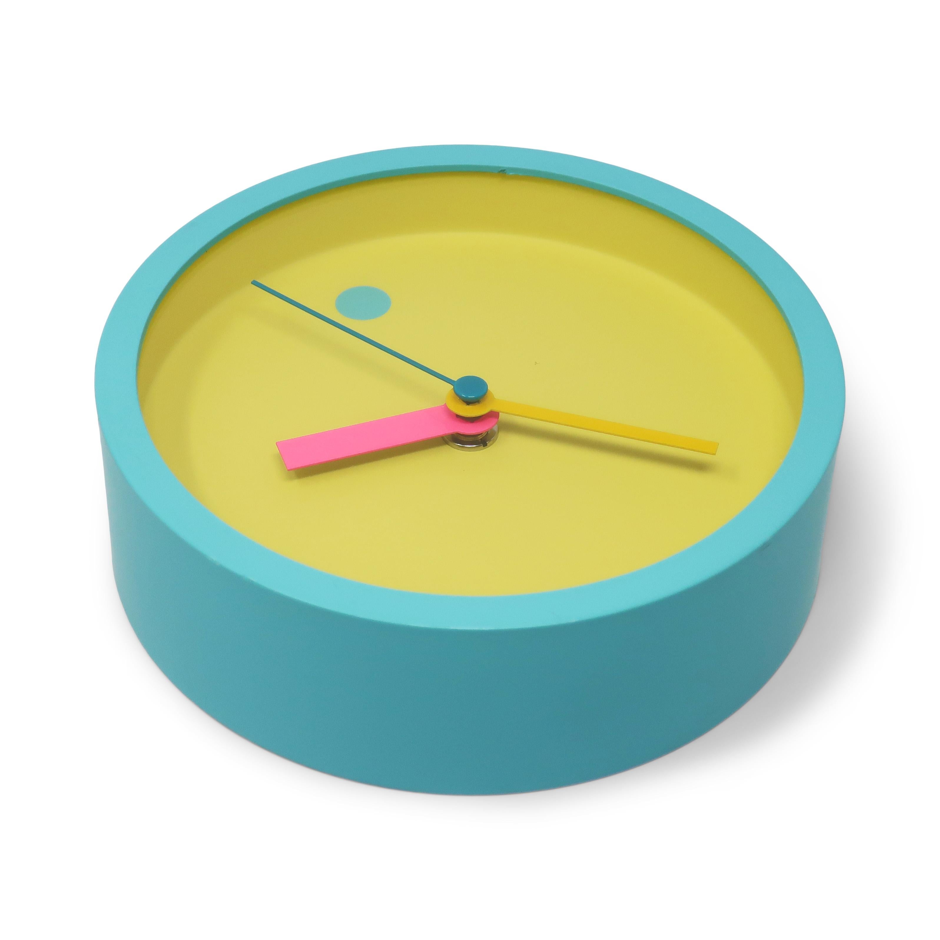 A perfectly elegant and sophisticated 1980s wall clock designed by Shohei Mihara for Wakita. Postmodern, Memphis Group-influenced design at its finest!  Pastel colored with light blue frame, yellow face, pink and green accents. Battery operated and