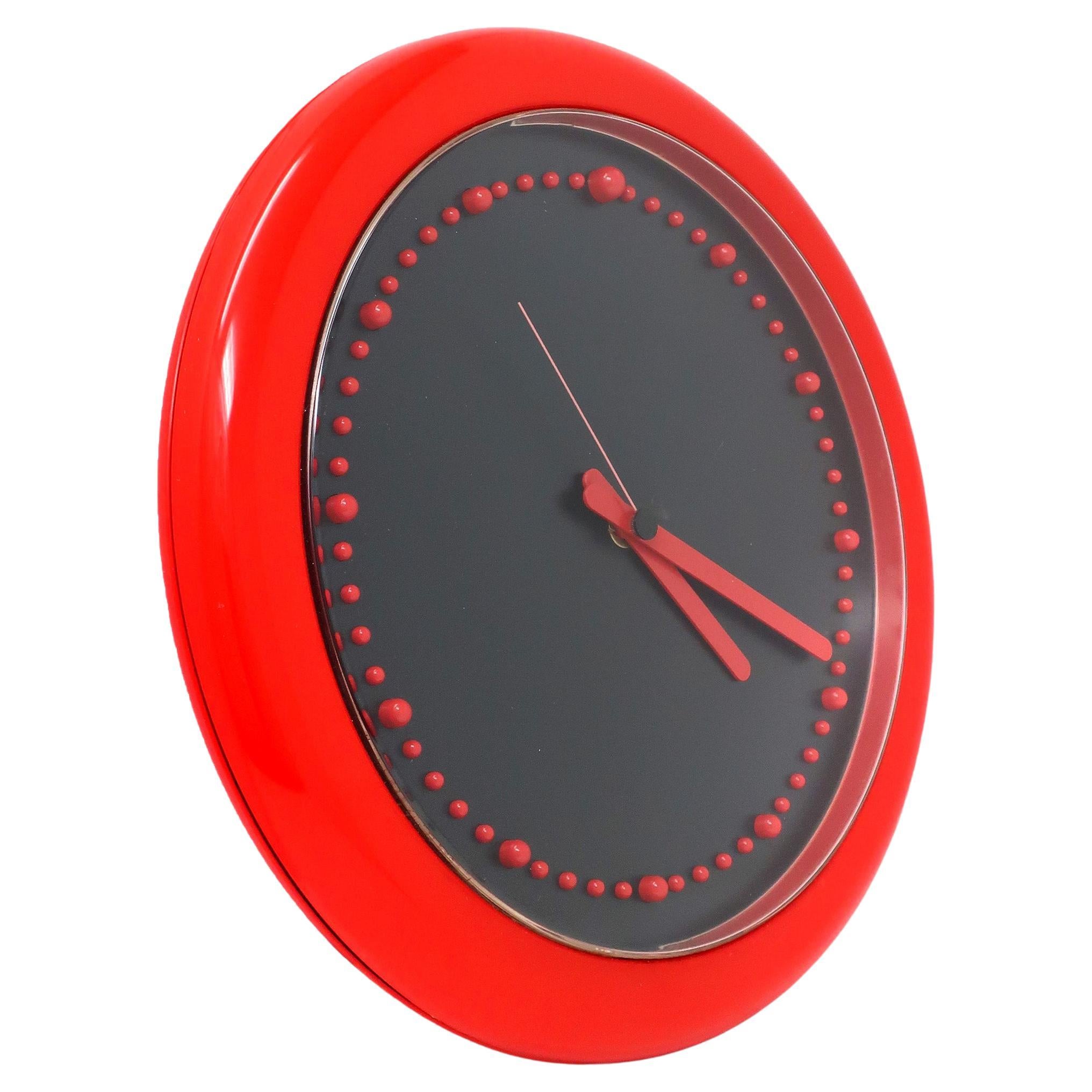 Designed by Raul Barbieri and Giorgio Marianelli for Rexite in 1981, this Zero 980 wall clock has a strikingly contrasting red and black color combination. Red plastic case, red hands, and raised red plastic bumps for the clock's numbers. Perfect