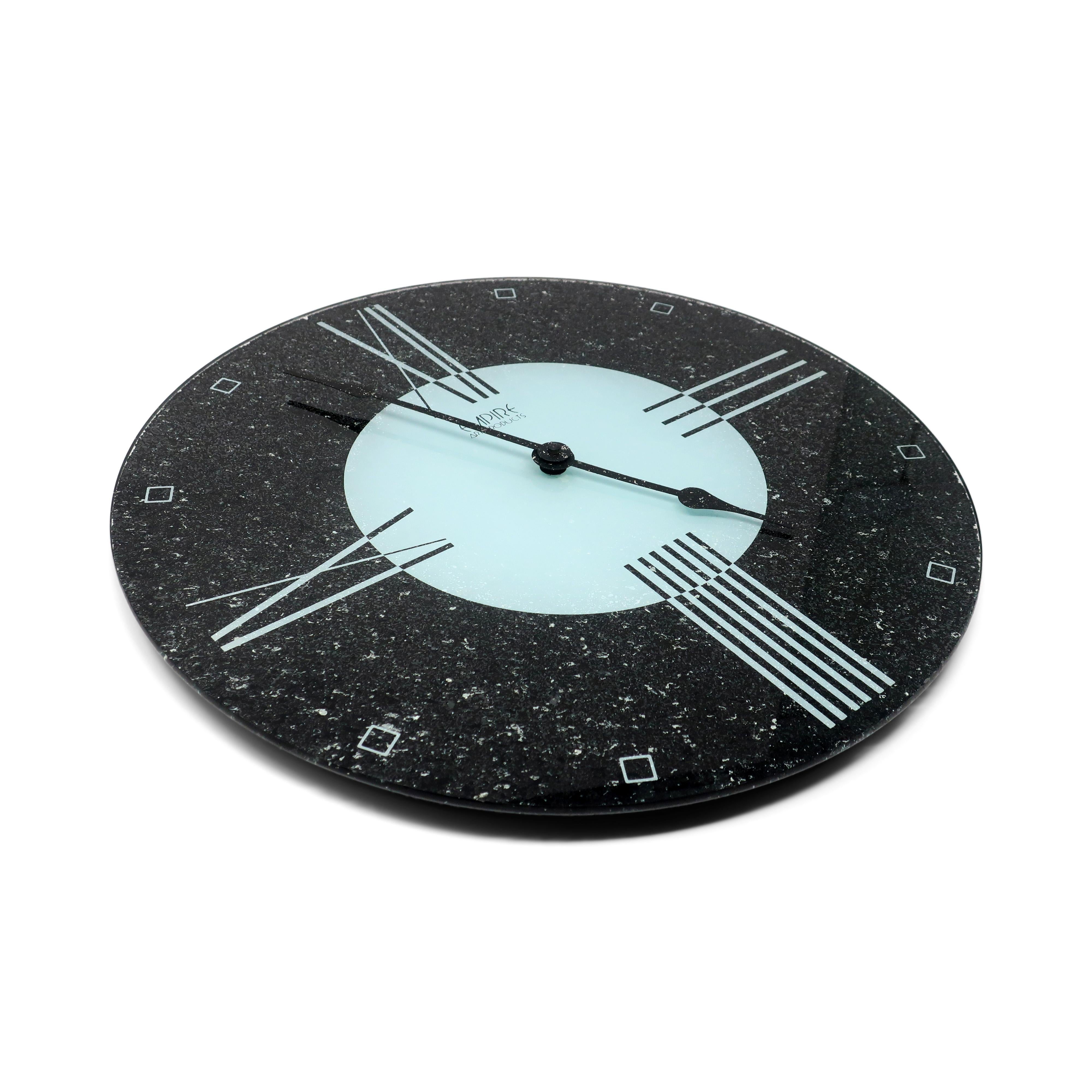 A postmodern Empire Art Products wall clock that looks like it could be straight out of a 1980s Swatch store or Pee Wee's Playhouse.  Black and light blue reverse painted glass with a speckled texture and black speckled hands.  Great 1980s Art Deco