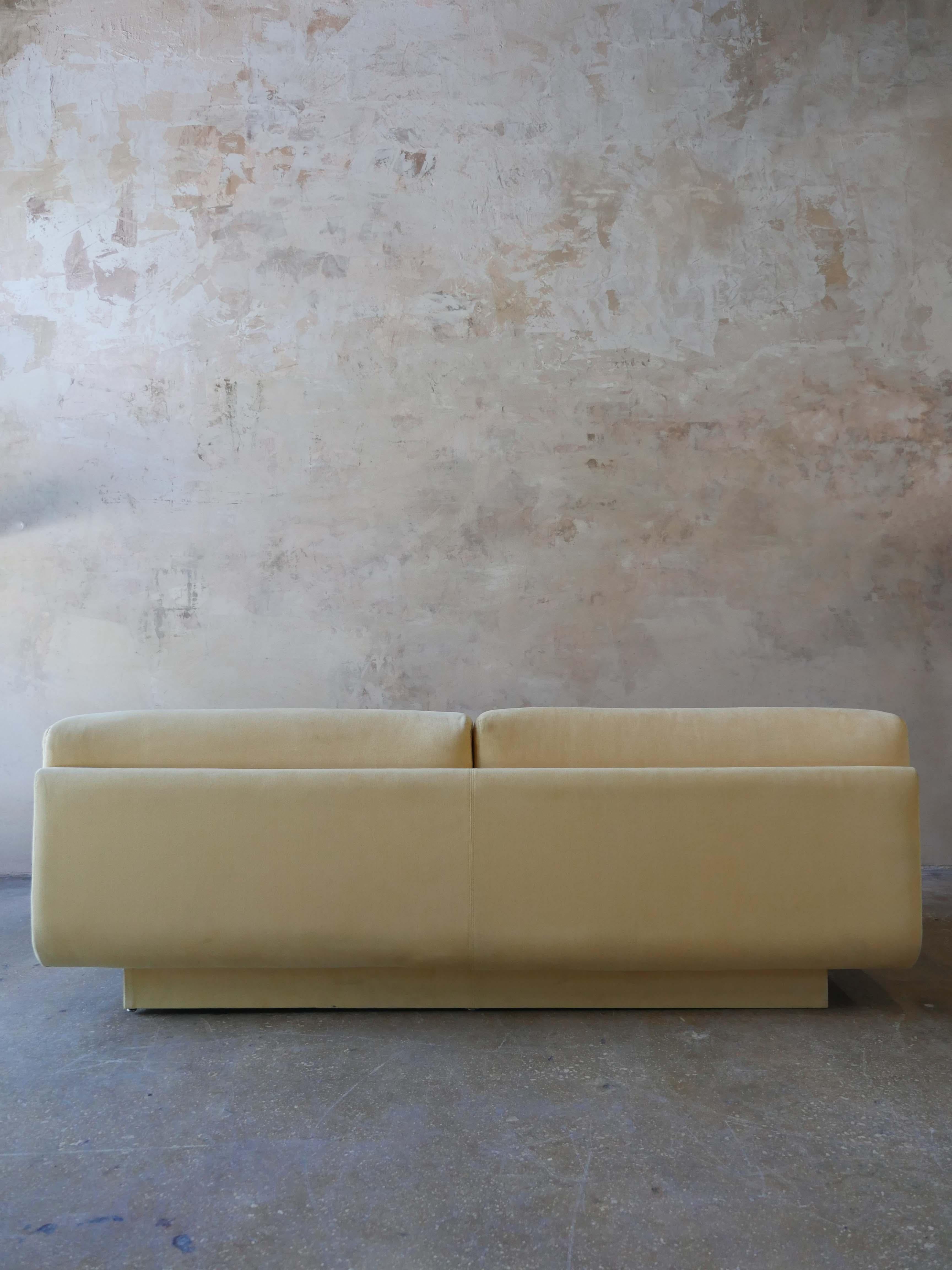1980s postmodern, suede yellow sofa by Preview. The sofa has a beautiful sculptural silhouette that fits well in a modern, or vintage setting.