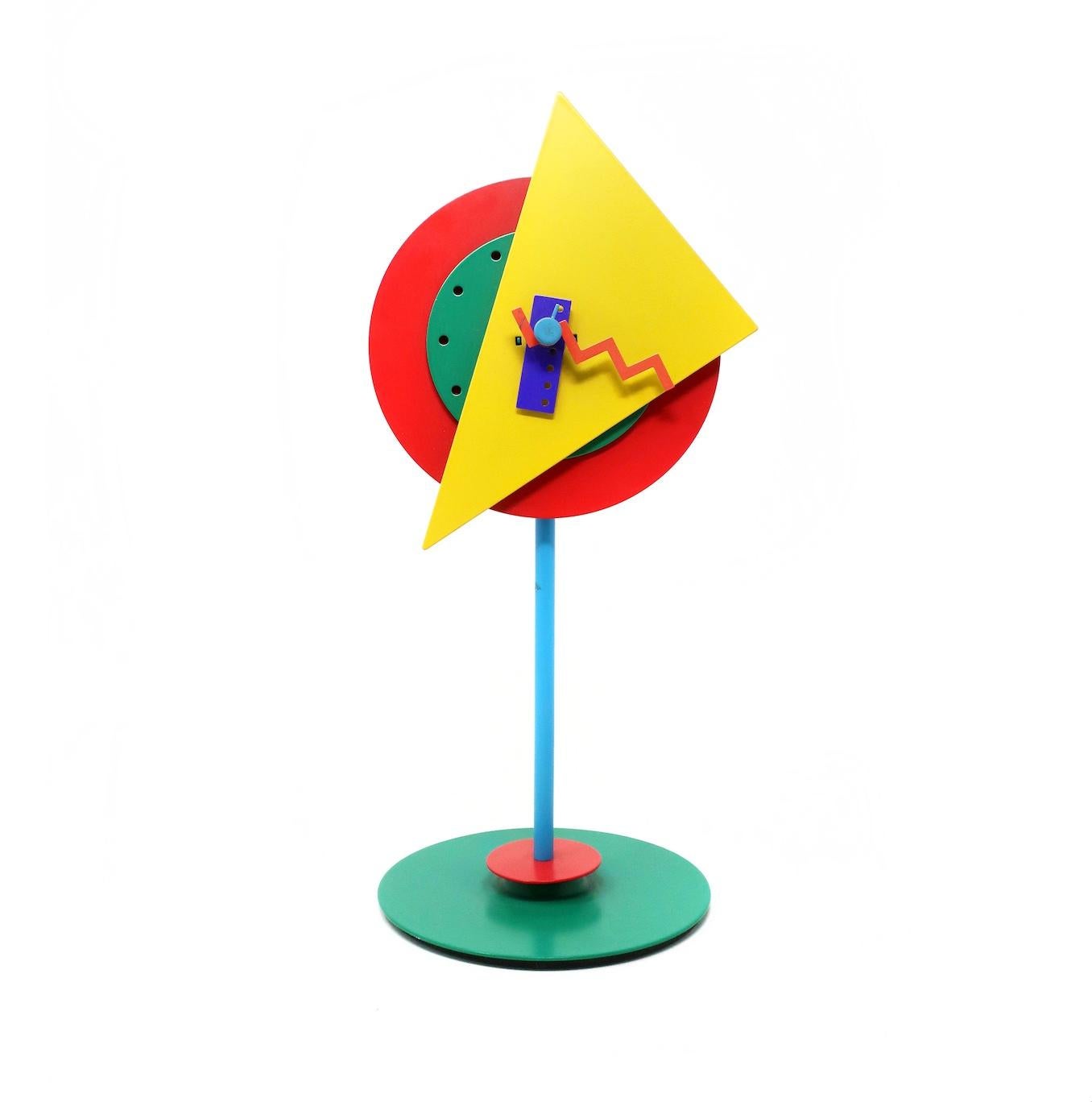 In keeping with Memphis Group-inspired designs of the 1980s, this whimsical desk or table clock use bright colors, geometric shapes, and contrast to unconventional and bold effect. Designed by Shohei Mihara for Wakita (a leading Japanese postmodern