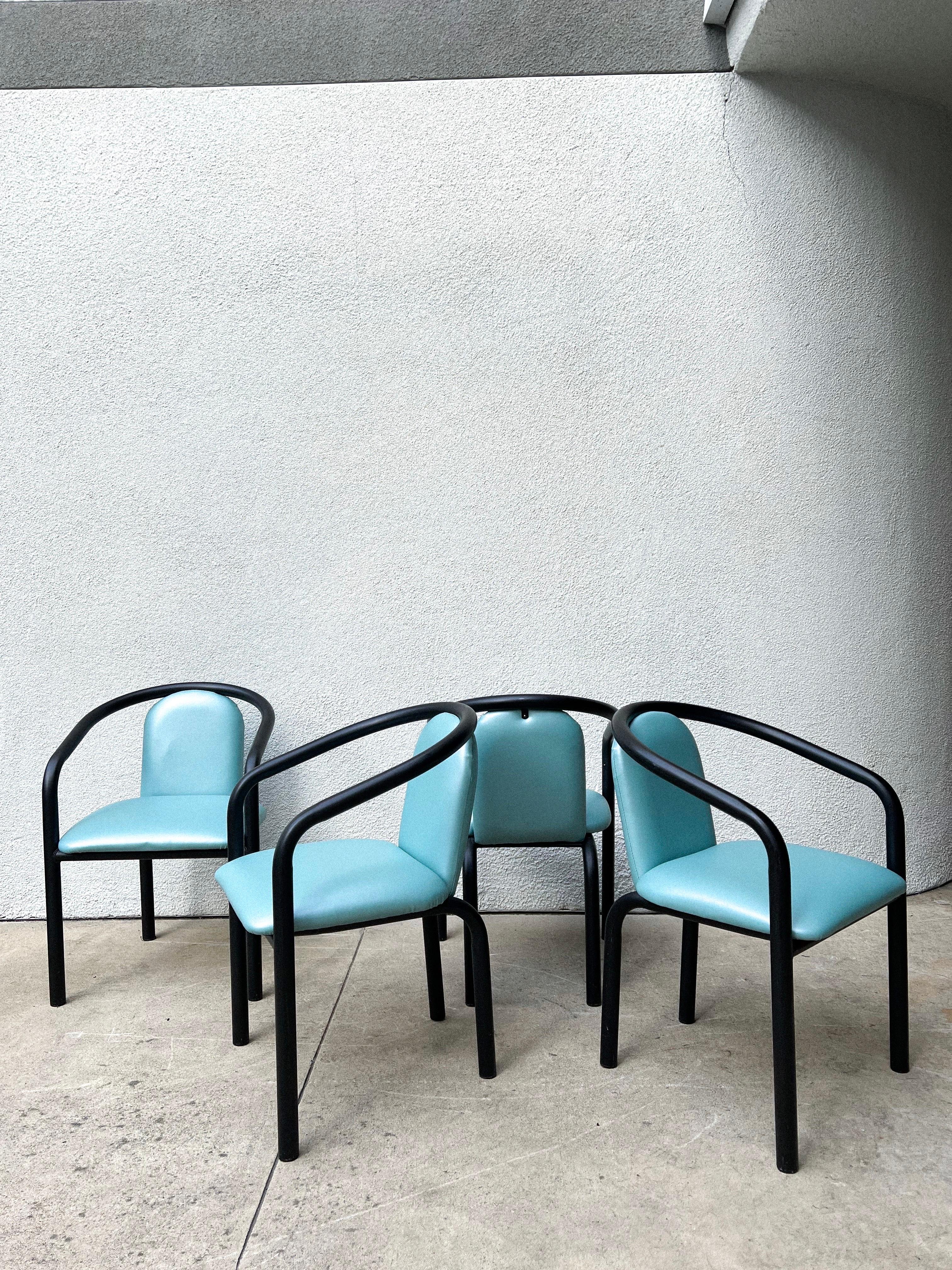 Set of 4 postmodern chairs featuring black chunky/tubular metal frames and flawless upholstery in an aqua hue vinyl.