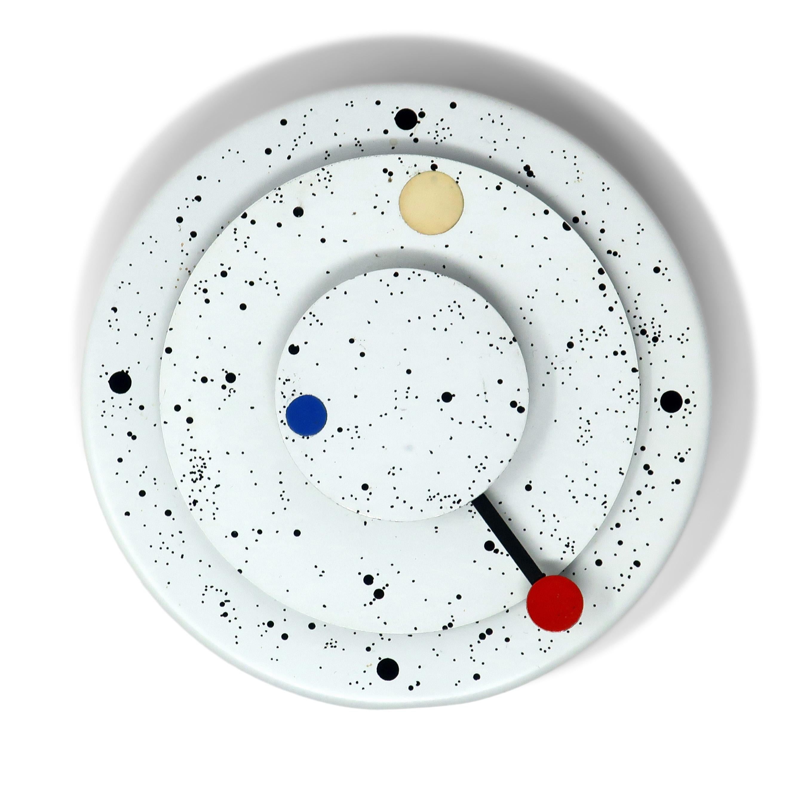 A stunning 1982 wall clock designed by Kovacs Design Group.  Round off-white and paint speckled body with concentric circle minute and hour hands.  

After studying in Vienna with Josef Hoffman, George Kovacs opened a modern and avant-garde lighting
