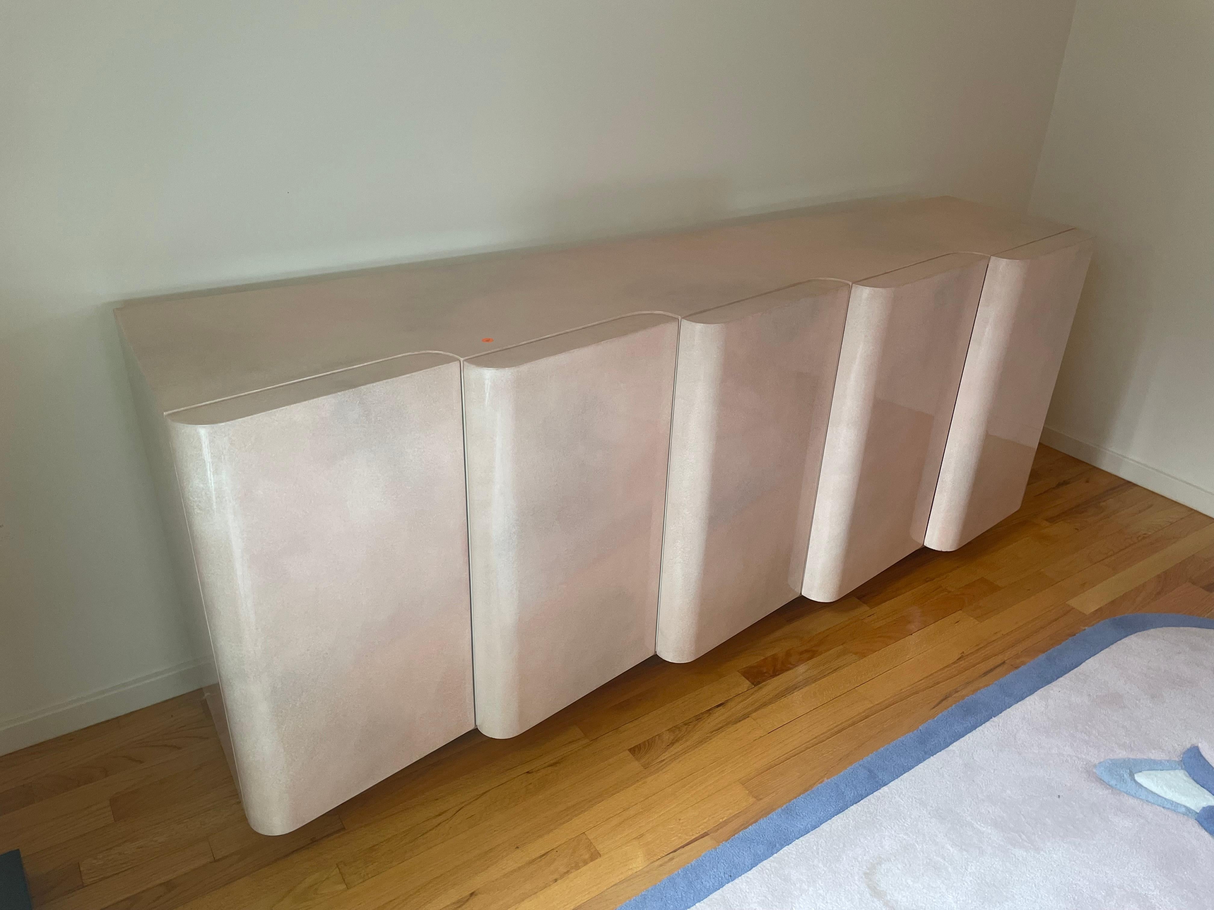 Stunning pink lacquered wavy front credenza with style and lots of storage