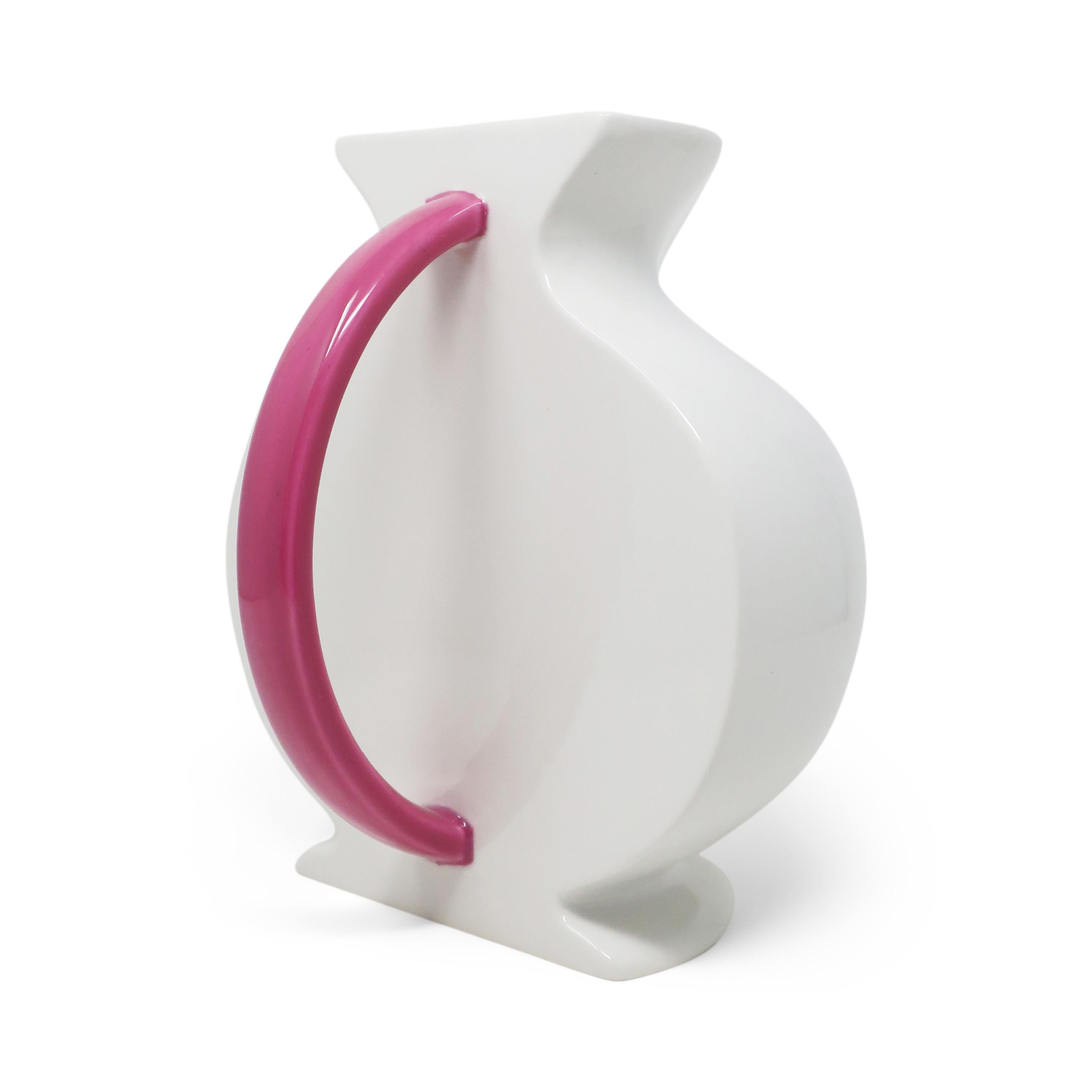 Stunning postmodern ceramic pitcher from the Hollywood collection designed by Marco Zanini for Flavia Montelupo/Bitossi. The white body, rounded pink handle, and flat back show a clear influence from the Memphis group designers, of which Zanini was