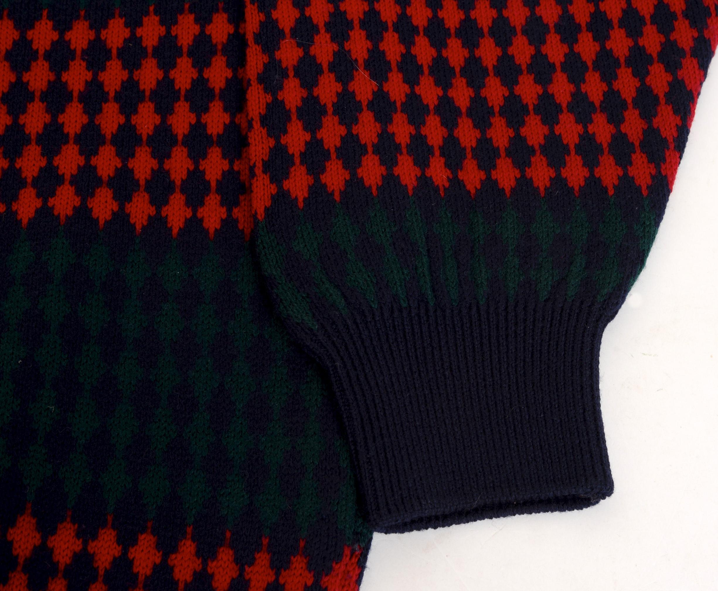 1980's Pringle of Scotland wool sweater has an alternating red/black checkerboard, red/green horizontal stripe throughout. The pullover has a solid black knit rib around the neck, sleeve cuffs, and hem. 100% lambswool.

Additional measurements-