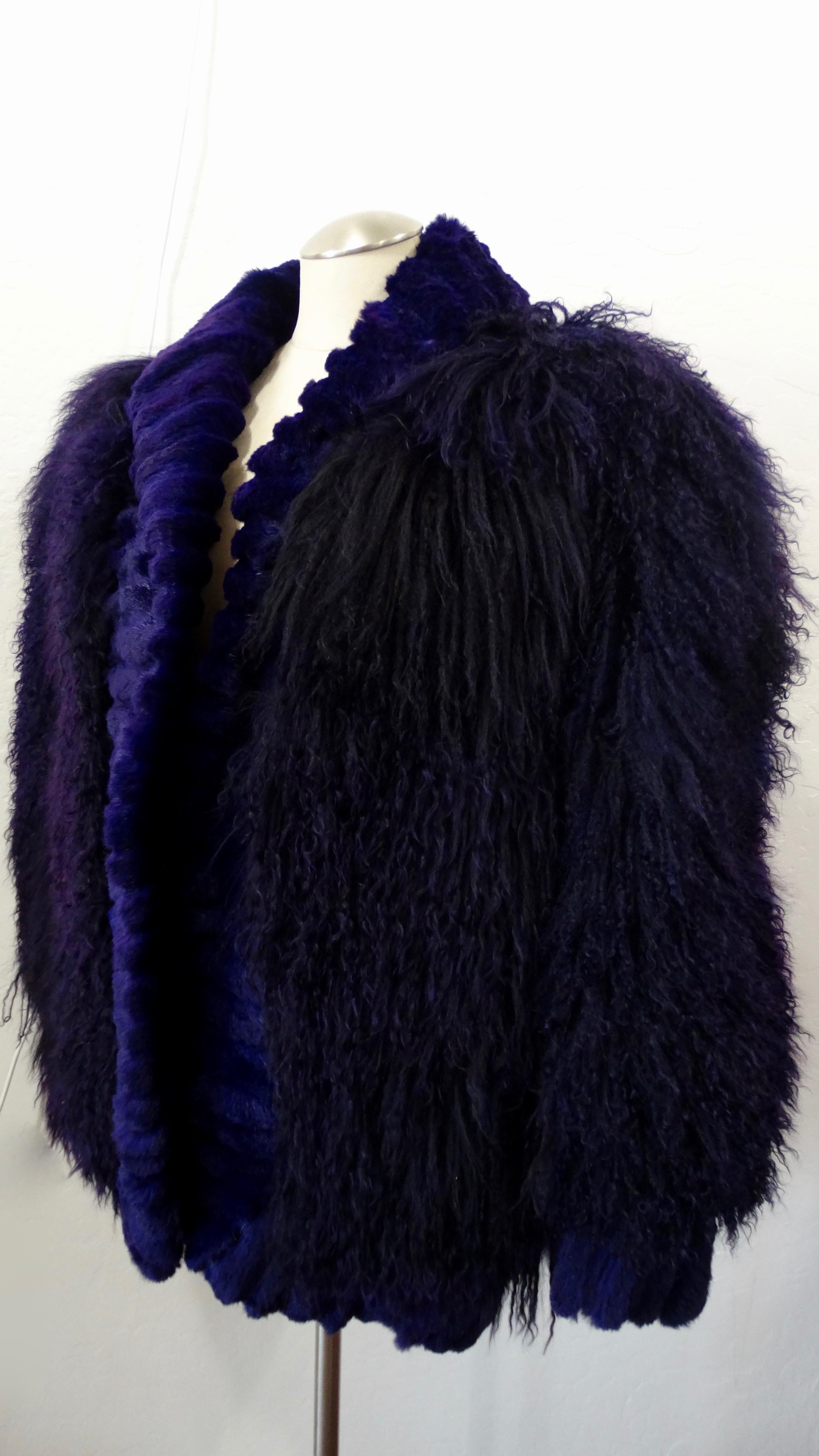 Take on the cold weather in style! Circa 1980s, this oversized jacket is made of soft purple dyed Mongolian lamb and features a tonal rabbit fur trim around the entire hem and cuffs. Includes two hook and eye closures and invisible pockets. Interior
