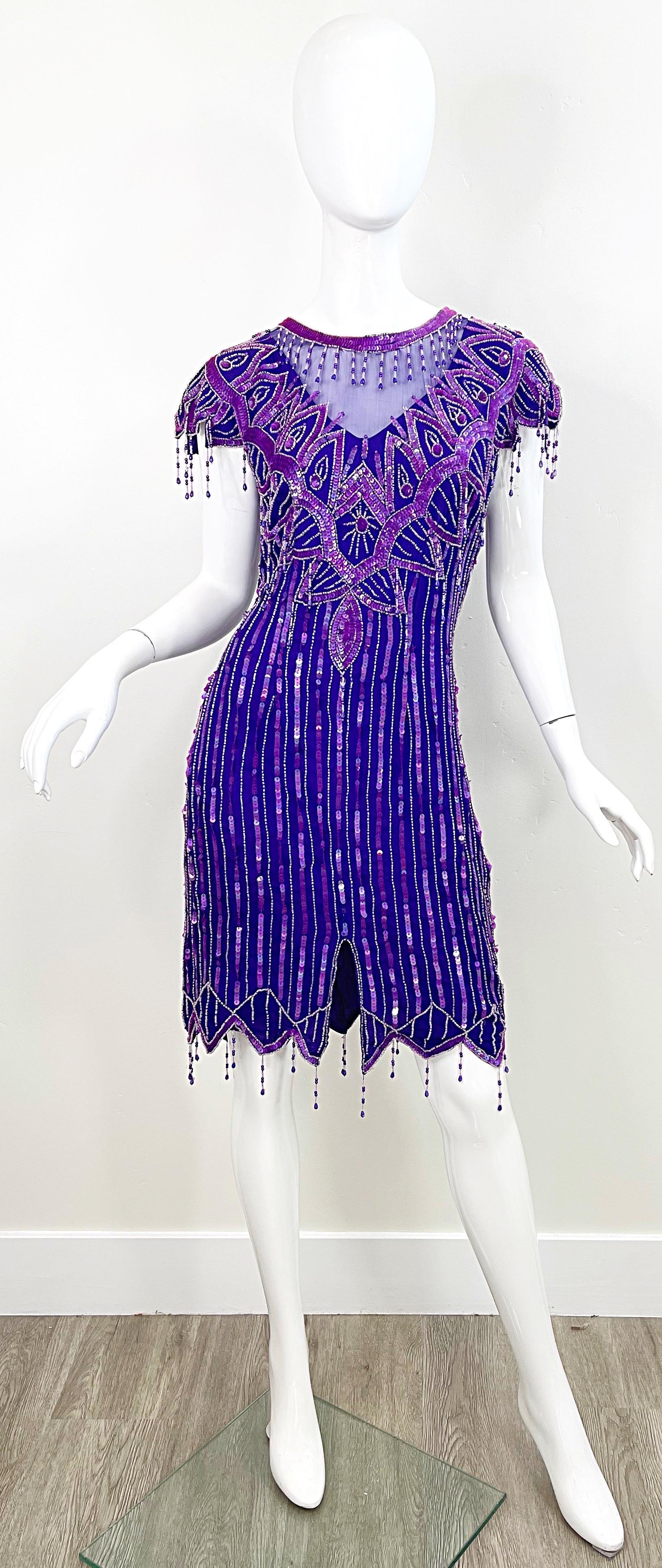 Amazing 1980s purple silk chiffon beaded and sequined flapper style cocktail dress ! Features thousands of hand-sewn sequins and beads throughout. Sheer chiffon bellow the neck. Hidden zipper up the back with hook-and-eye closure. Very well made