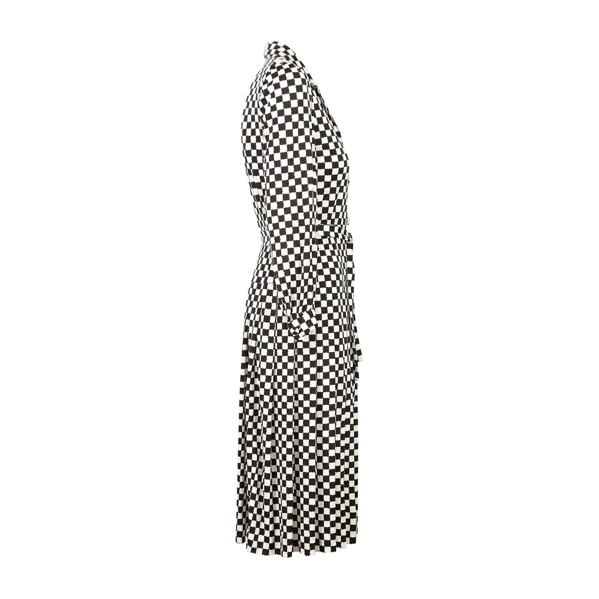 This timeless monochrome checkerboard patterned dress was designed in the late 1970s to early 1980s by Racine. The style is so timeless, it could pass for designs from the mid 60s through to the 90s and would be a great choice for a race meet such