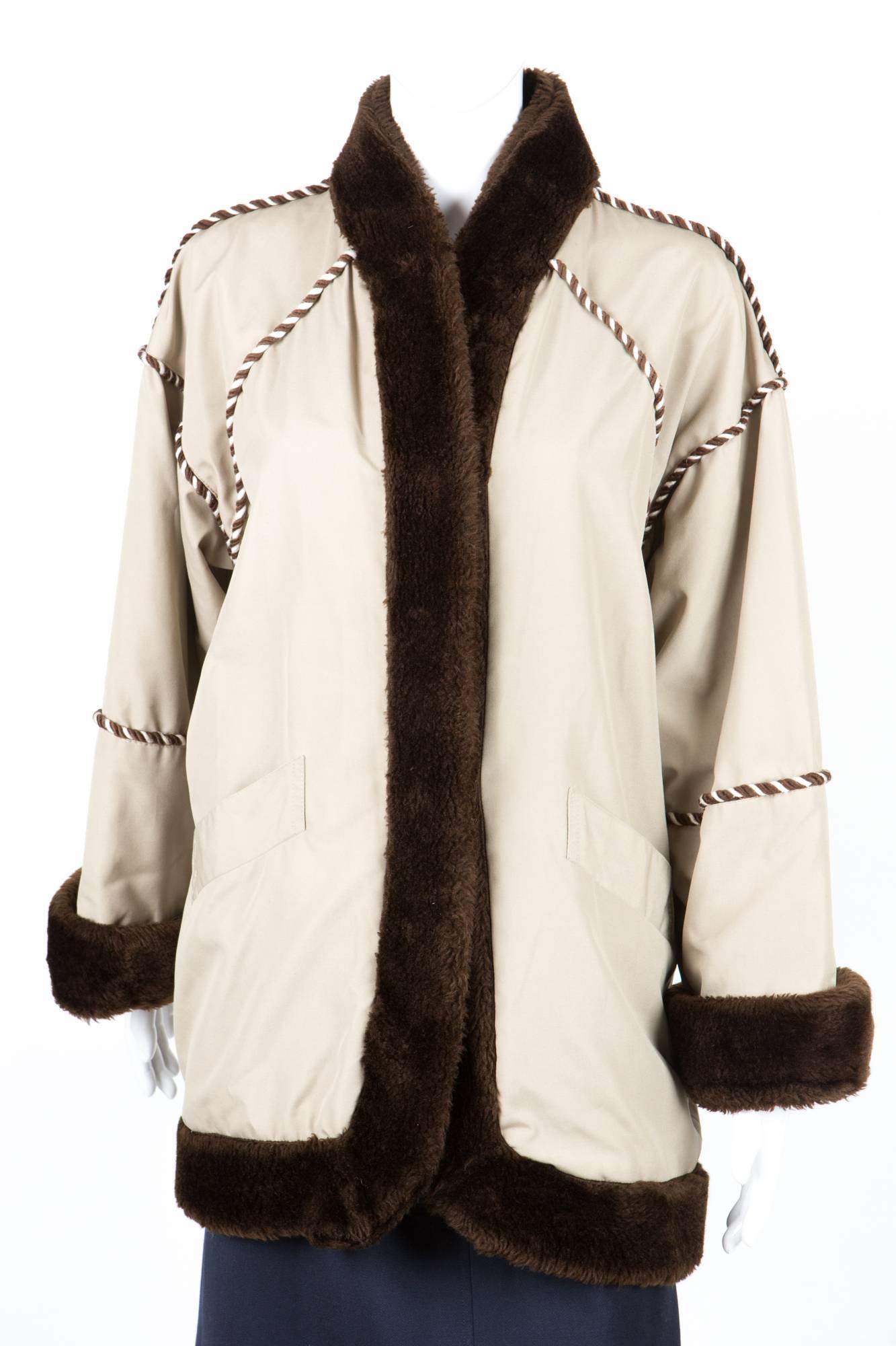 1980s Rare Yves Saint Laurent camel pelisse coat featuring front hook opening, cotton outside, brown sheep fur finishing, an inside detachable brown sheep fur lining, braided finishing, front pockets.
Estimated size: 40fr/US8/UK12
Chest 45,6 in. (